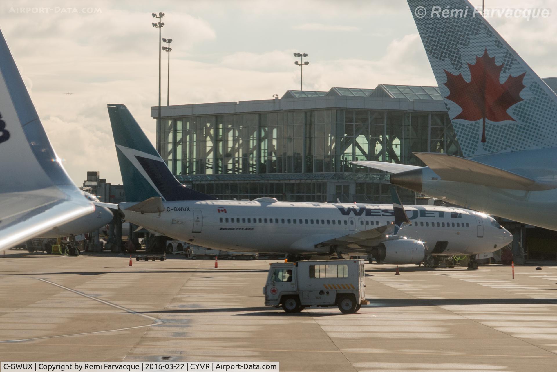 C-GWUX, 2014 Boeing 737-8CT C/N 60124, Parked at International Terminal, shot from another aircraft.