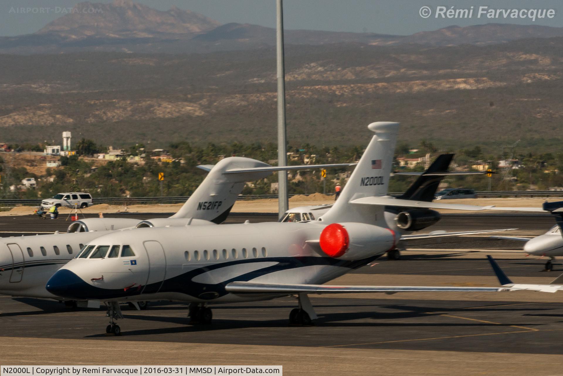N2000L, 1999 Dassault Falcon 2000 C/N 92, New livery since last photographed, plus bulge added to top of tail. Parked north of main terminal building, private jet area.