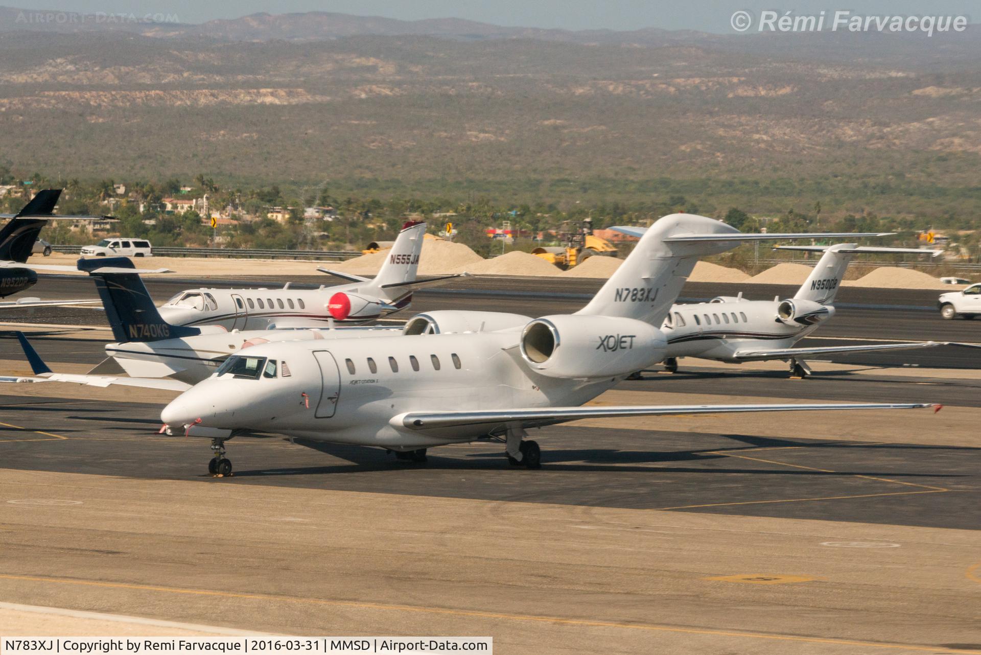 N783XJ, 1999 Cessna 750 Citation X C/N 750-0083, Parked north of main terminal building in area for private craft. Photographed from another aircraft.