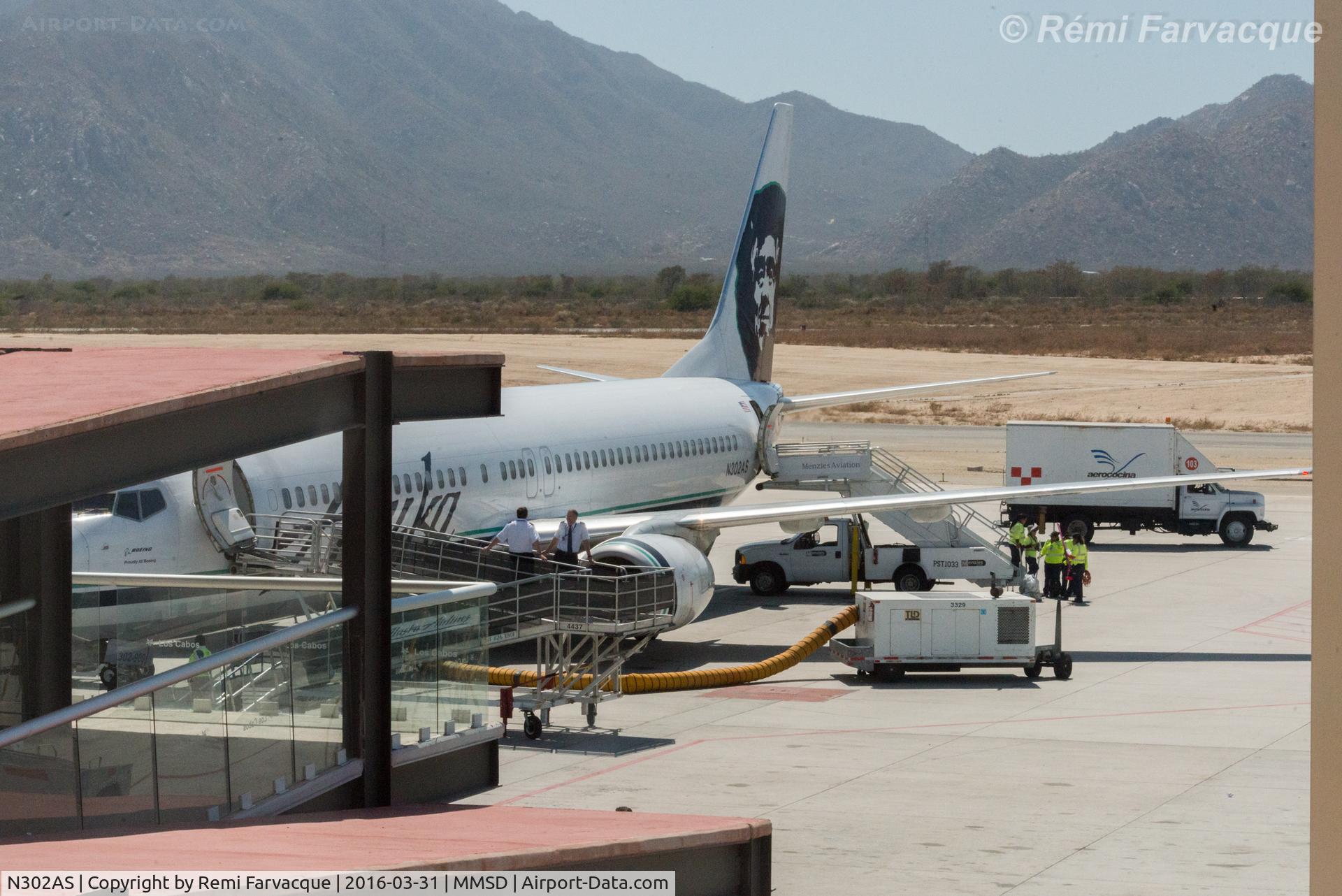 N302AS, 2003 Boeing 737-990 C/N 30017, Rampside chat by pilots. In front of main terminal building.