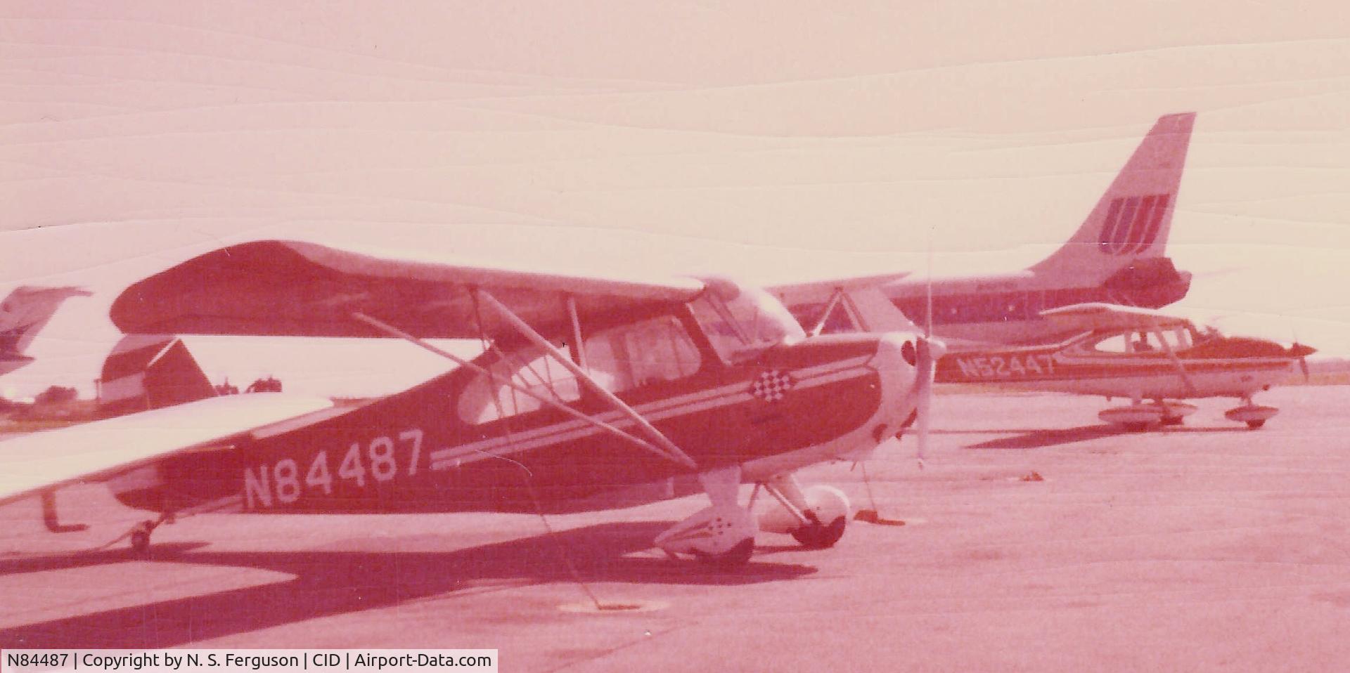 N84487, 1946 Aeronca 7AC Champion C/N 7AC-3185, Circa 1980.  Photo faded, unfortunately, before it was scanned.  Primary color was a yellowish tan.  Tied down at the Cedar Rapids, IA (CID) airport just prior to a static display airshow.