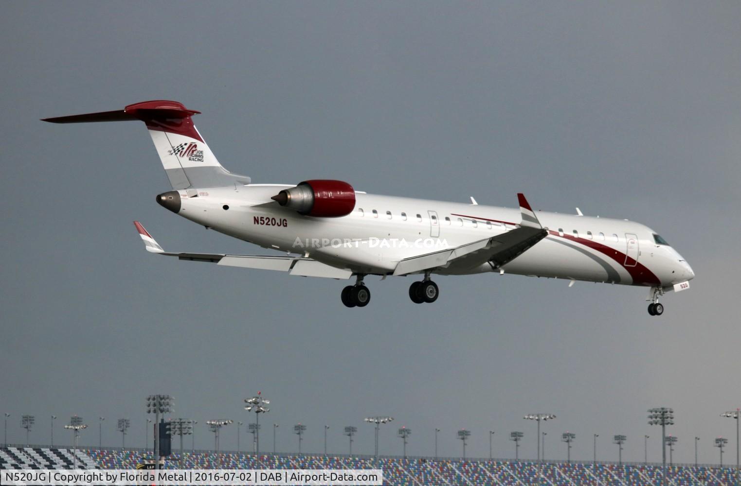 N520JG, 2002 Bombardier CRJ-701ER (CL-600-2C10) Regional Jet C/N 10052, Joe Gibbs Racing NASCAR Team landing before a storm by the Daytona International Speedway