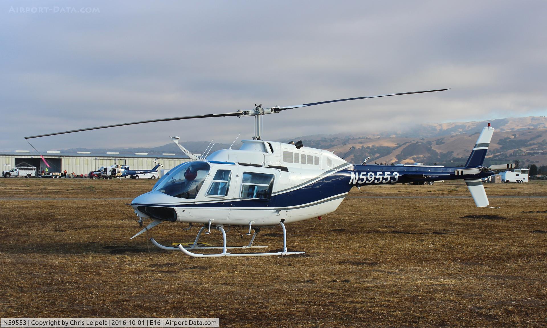 N59553, 1974 Bell 206B JetRanger C/N 1451, Sycan Corp (Paso Robles, CA) 1974 Bell 206B parked in the grass at South County Airport, San Martin, CA to help fight the Loma fire.