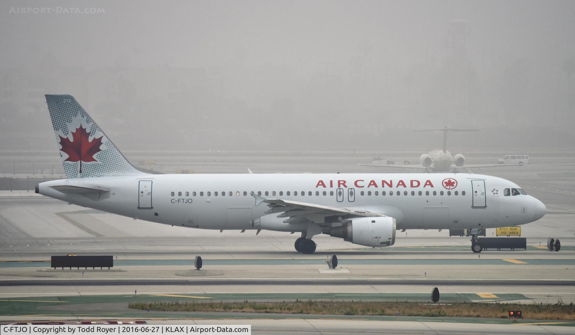 C-FTJO, 1991 Airbus A320-211 C/N 183, Taxiing at LAX on a foggy morning
