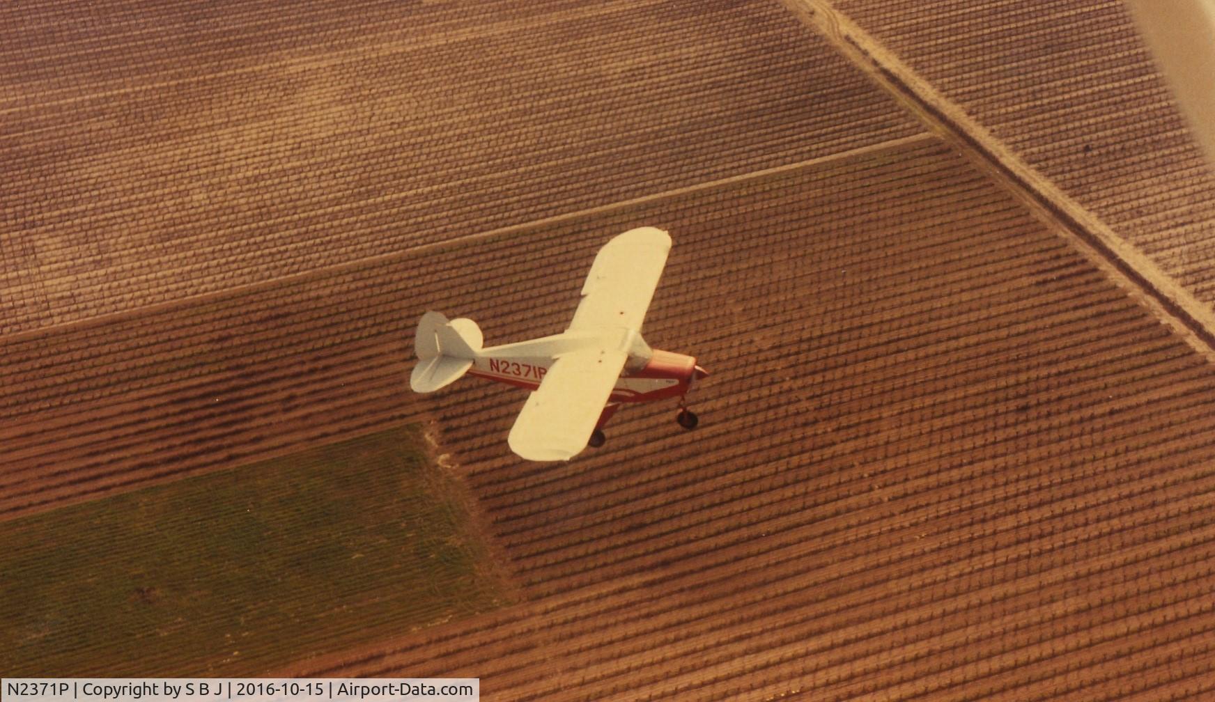 N2371P, 1955 Piper PA-22-150 Tri-Pacer C/N 22-2762, 71P seen flying over central California farmland, most likely grapevines.