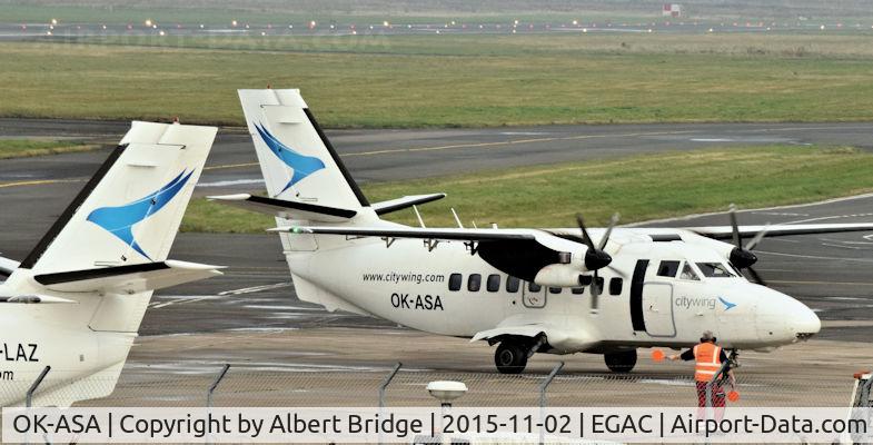 OK-ASA, 1990 Let L-410UVP-E Turbolet C/N 902439, Two Let Turbolets together at Belfast City.  The Isle of Man had been badly affected by fog.  OK-LAZ (left) had returned, unable to land, with an early-morning flight.  OK-ASA is arriving with a slightly delayed flight due just before noon.