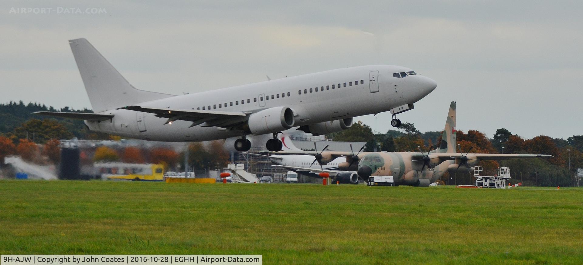 9H-AJW, 1998 Boeing 737-3U3 C/N 28733, Departing to Lasham past Oman AF C130 505 and 9H-MTF