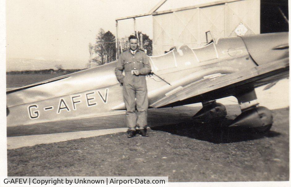 G-AFEV, Miles M14A Hawk Trainer 3 C/N 558, Trainee pilot L. J. Endicott standing in front of G-AFEV at Roborough Aerodrome, Plymouth, Devon in the late 1930s.