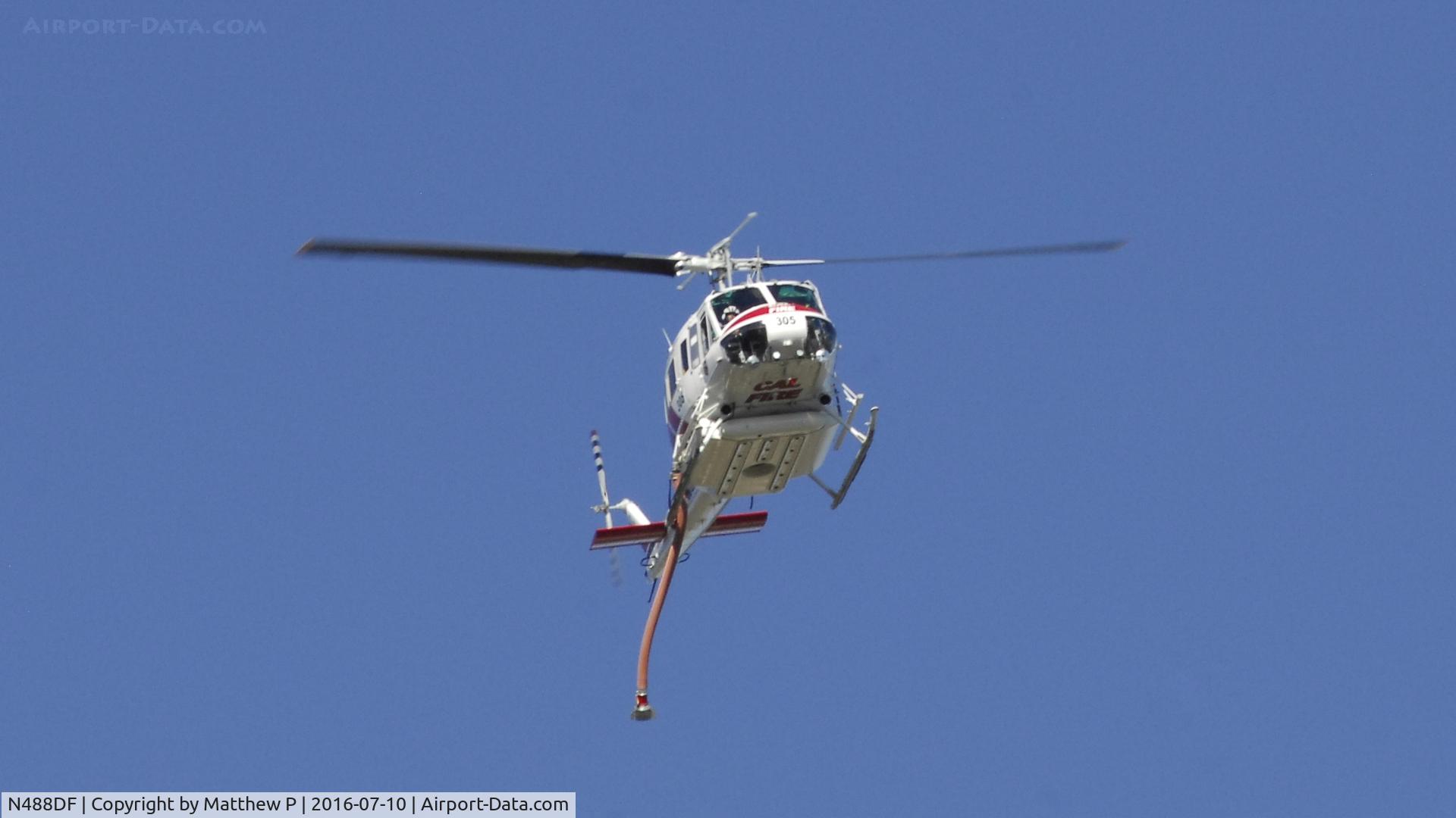 N488DF, 1969 Bell UH-1H-BF Iroquois C/N 11527, CalFire Chopper 305 passes overhead before picking water up from a nearby pond in support of a Riverbed Fire on the Jurupa Valley/Riverside City line.