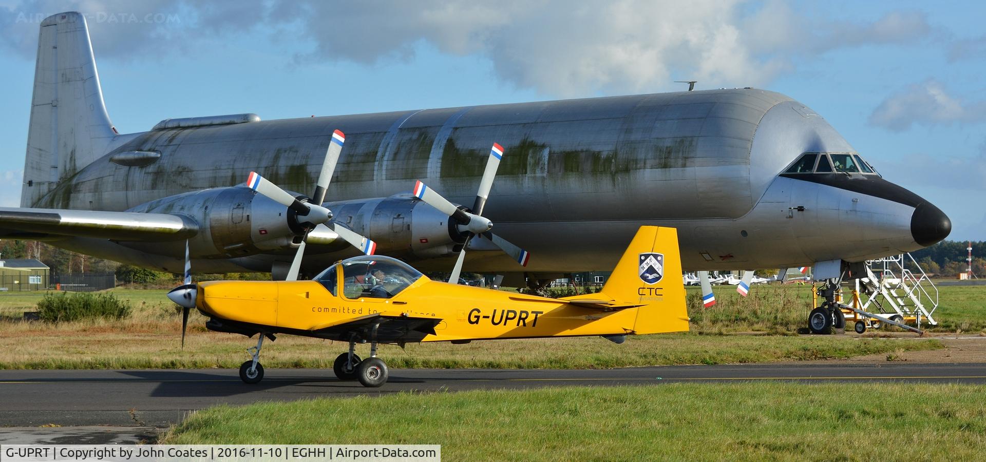 G-UPRT, 1997 Slingsby T-67M-260 Firefly C/N 2255, Taxiing past a decaying Guppy