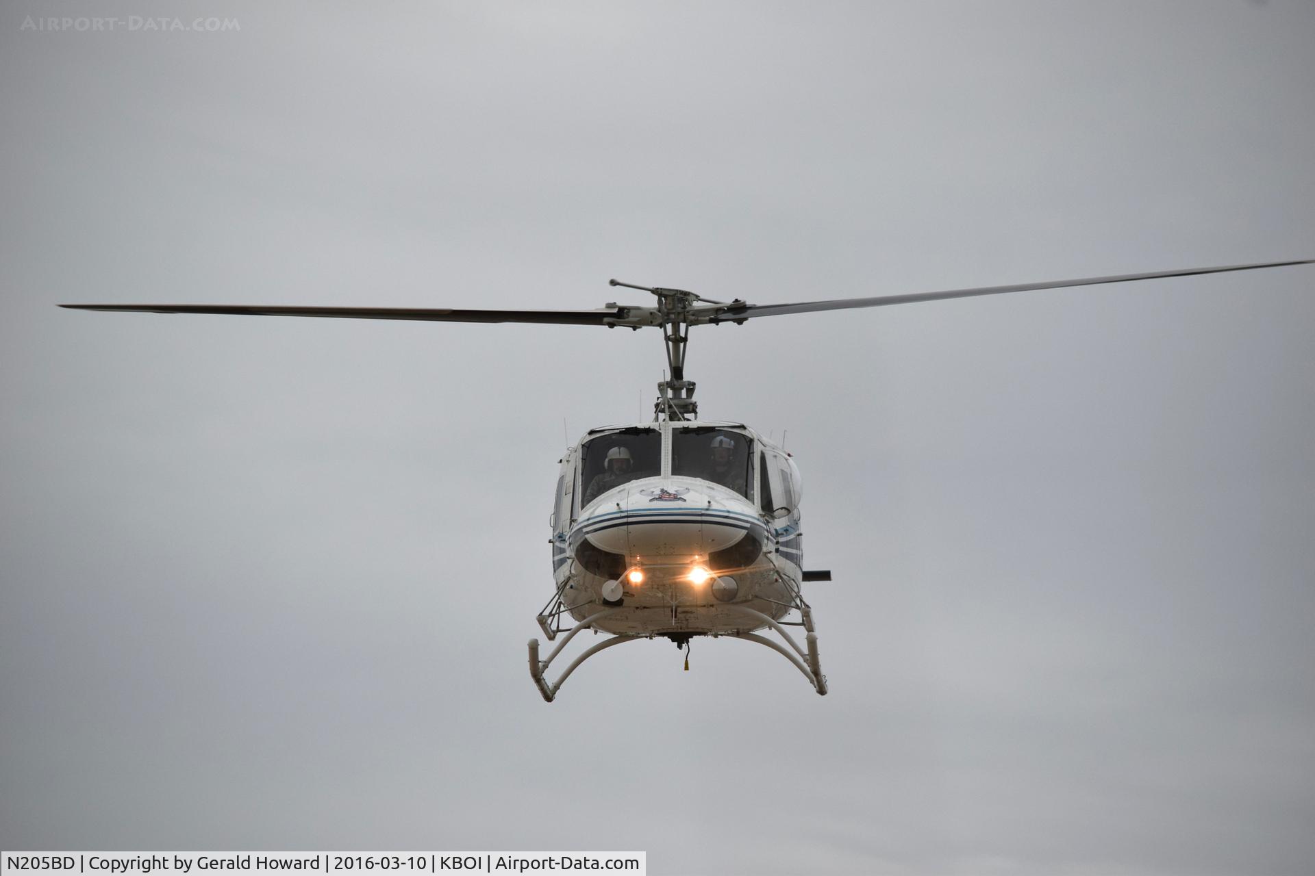 N205BD, 1971 Bell 205A-1 C/N 30097, Flying west bound along Taxi way Alpha.