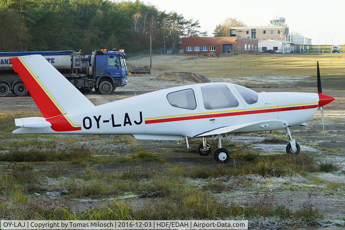 OY-LAJ, 1990 Socata TB-9 Tampico C/N 1090, Airport building and tower of HDF/EDAH (Heringsdorf, Germany)  in the background