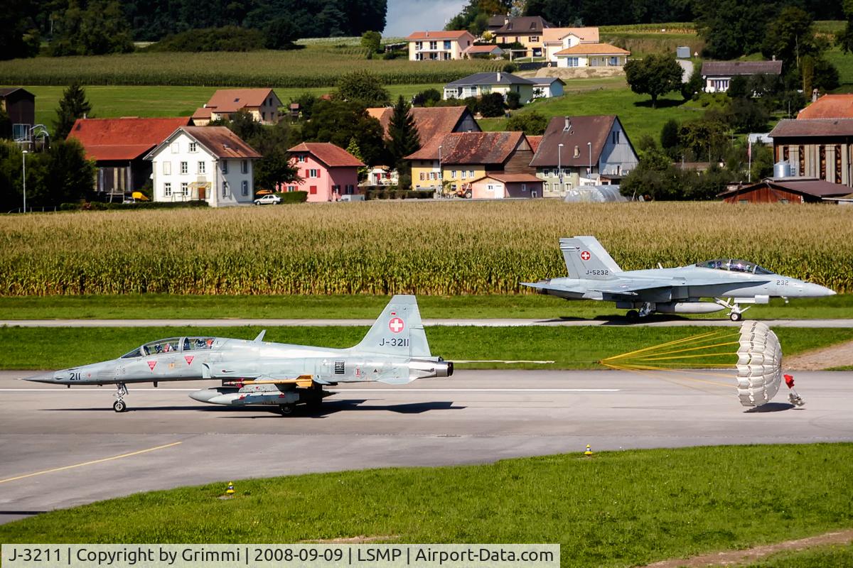 J-3211, 1981 Northrop F-5F Tiger II C/N M1011, equipped for electronic warfare, together with Hornet J-5232 behind the brakechute