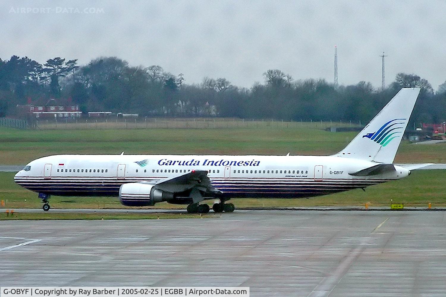 G-OBYF, 1998 Boeing 767-304 C/N 28208, Boeing 767-767-304ER [28208] (Garuda Indonesia) Birmingham Int'l~G 25/02/2005. Some markings on the glass of the terminal window.