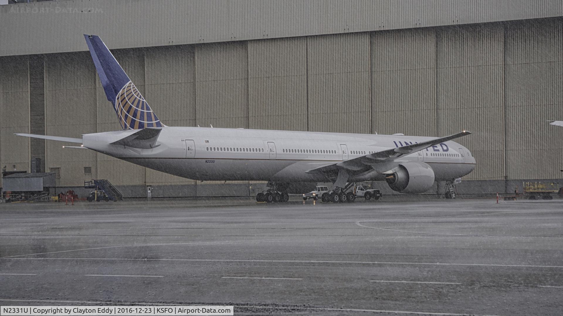 N2331U, 2016 Boeing 777-322/ER C/N 62642, United's new and first 777-300 on a rainy ramp.