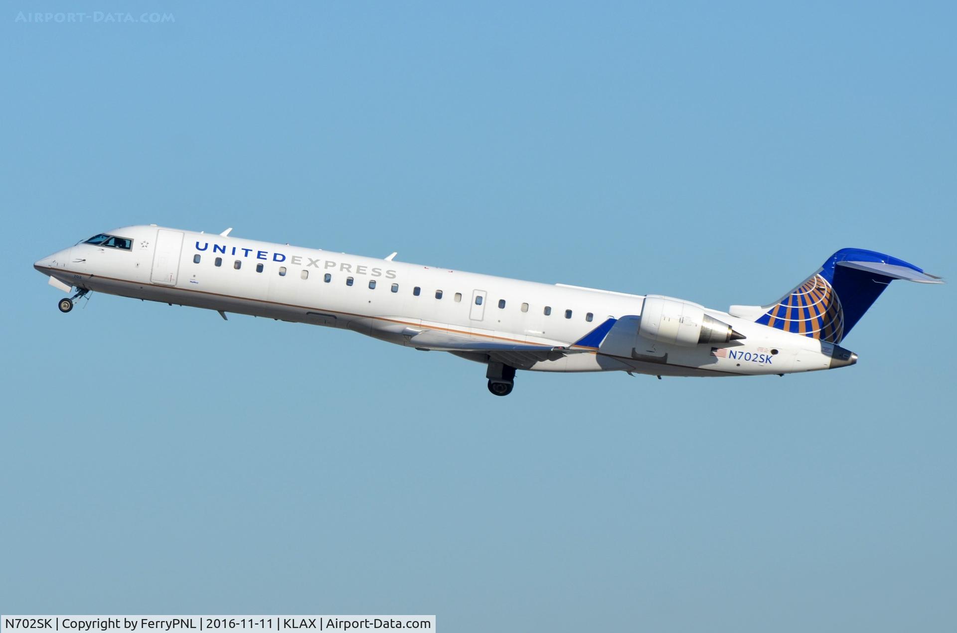 N702SK, 2004 Bombardier CRJ-701ER (CL-600-2C10) Regional Jet C/N 10136, United CL700 departing.