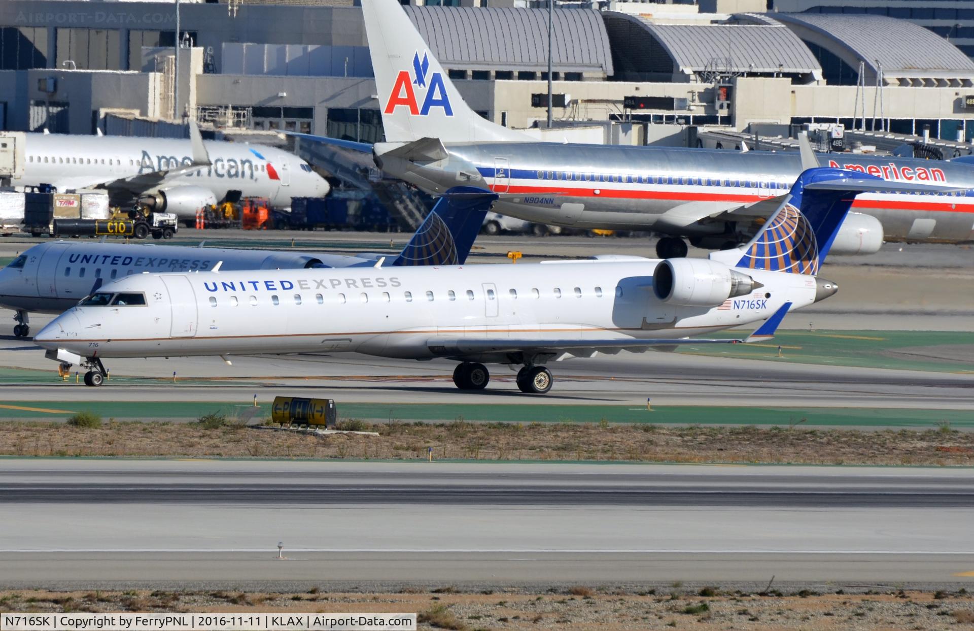 N716SK, 2004 Bombardier CRJ-701ER (CL-600-2C10) Regional Jet C/N 10180, United Express rush hour.