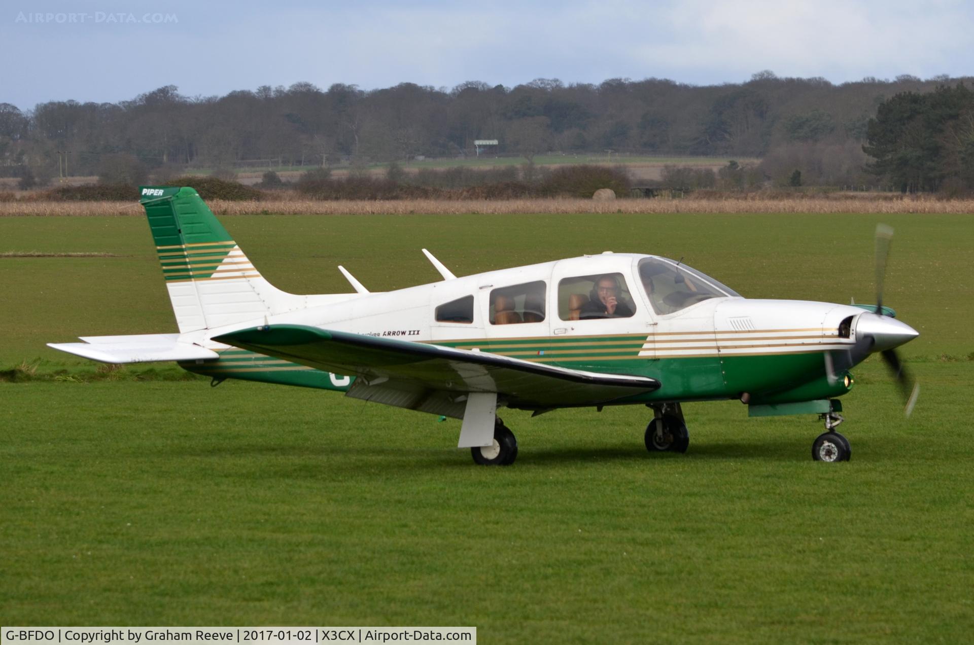 G-BFDO, 1977 Piper PA-28R-201T Cherokee Arrow III C/N 28R-7703212, Just landed at Northrepps.
