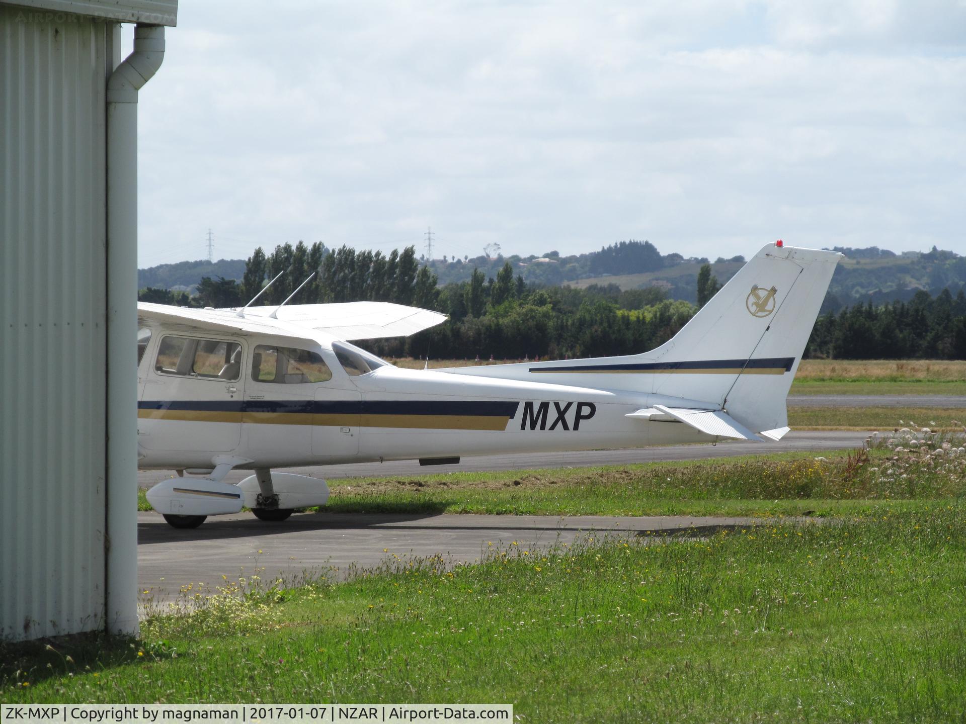 ZK-MXP, Cessna R172K Hawk XP C/N R172-2915, hiding behind hangar at ardmore
