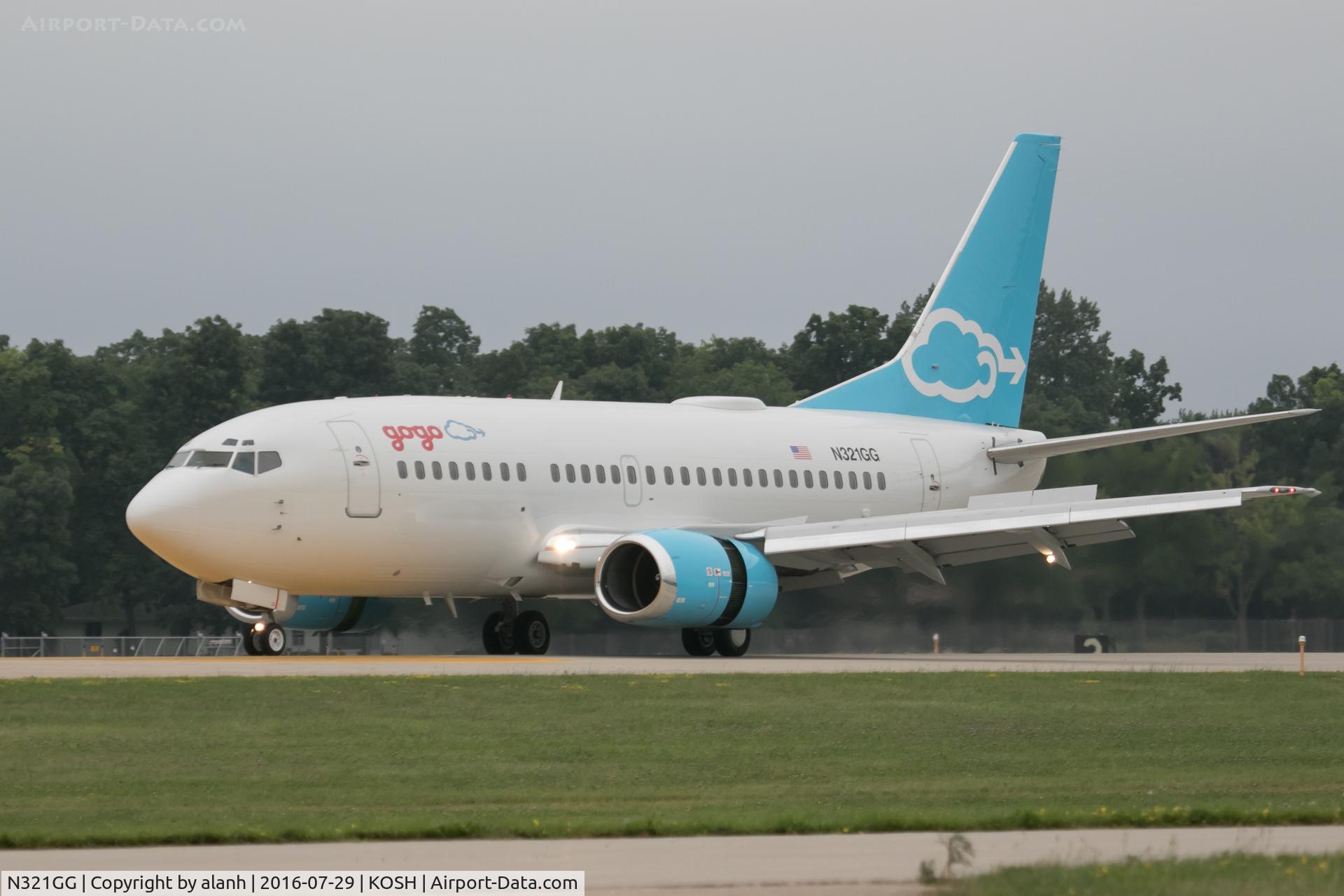 N321GG, 1992 Boeing 737-5H6 C/N 26445, Arriving at AirVenture 2016. [Four obtrusive orange cones have been cloned out of the foreground grass]