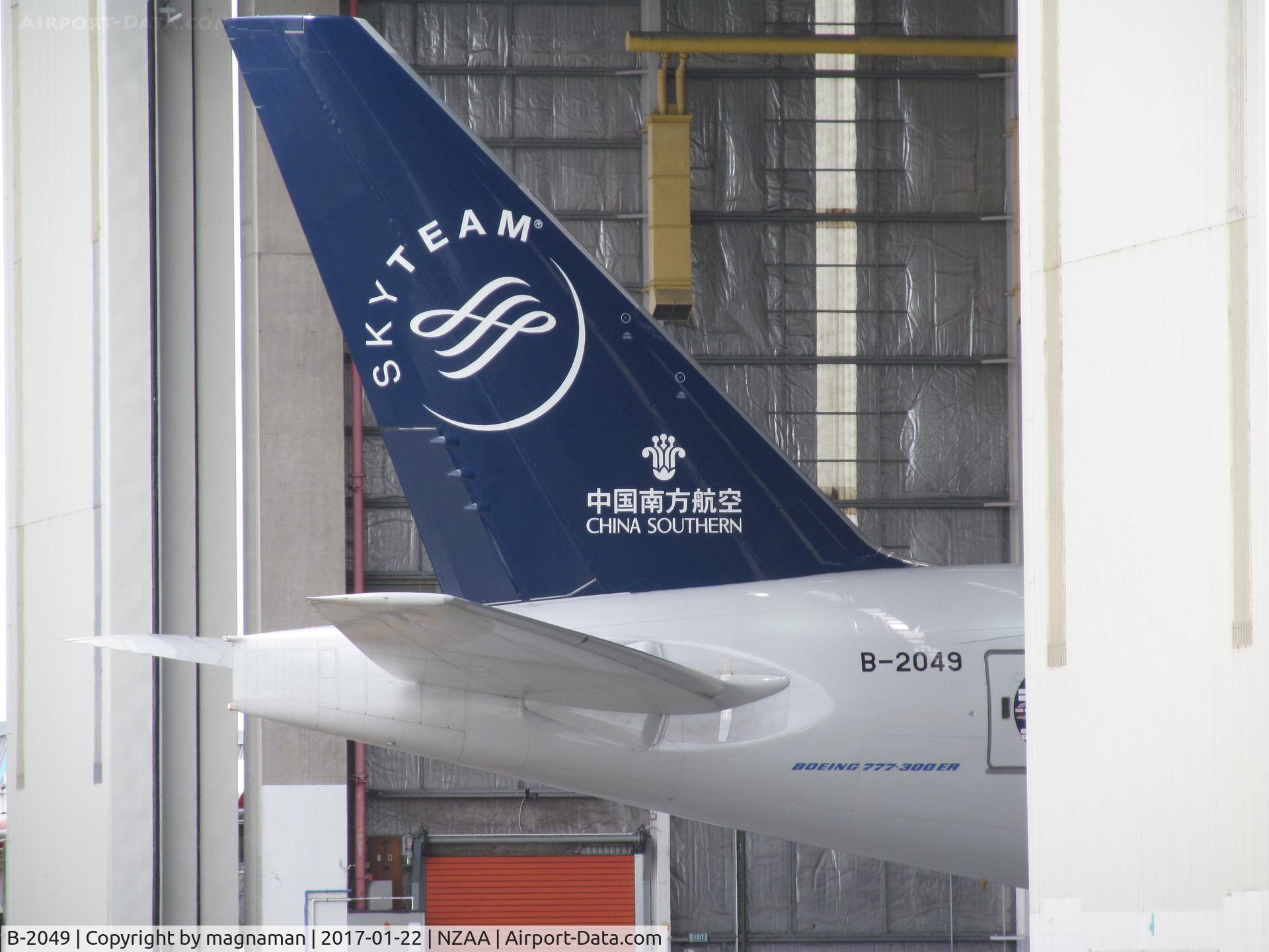 B-2049, 2015 Boeing 777-31B/ER C/N 43225, poking out of air NZ maintenance hangar