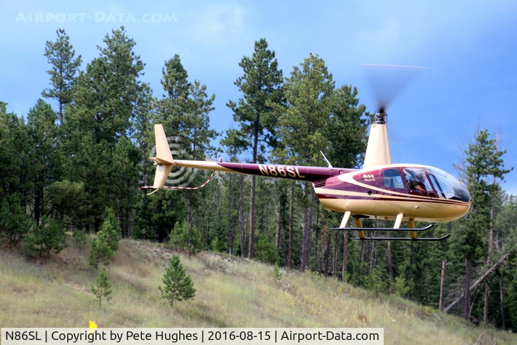 N86SL, 2004 Robinson R44 II C/N 10375, N86SL R44 departing a roadside helipad near Custer SD