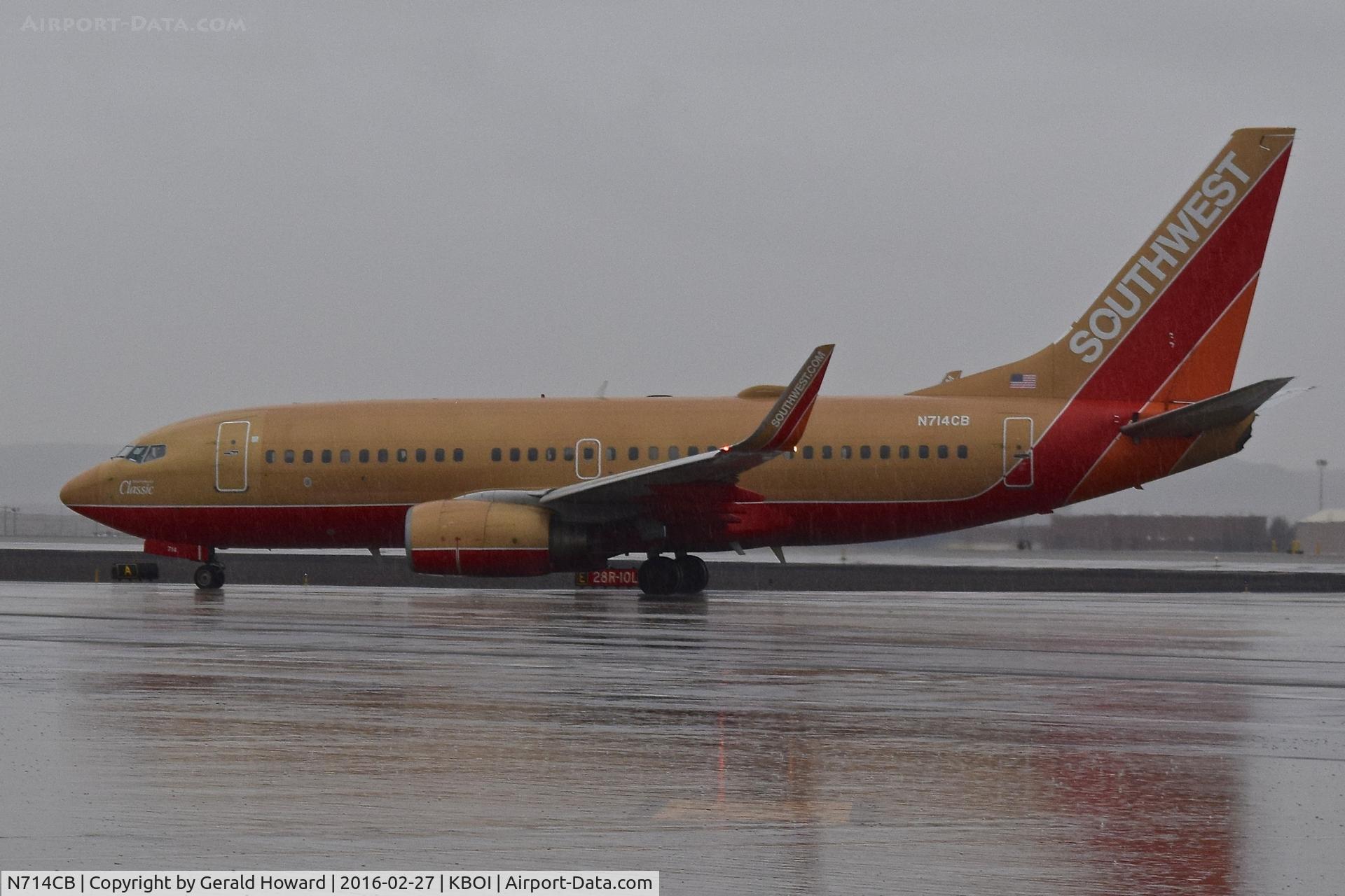 N714CB, 1998 Boeing 737-7H4 C/N 27848, Taxi off RWY 28R to the ramp in a driving rain storm.