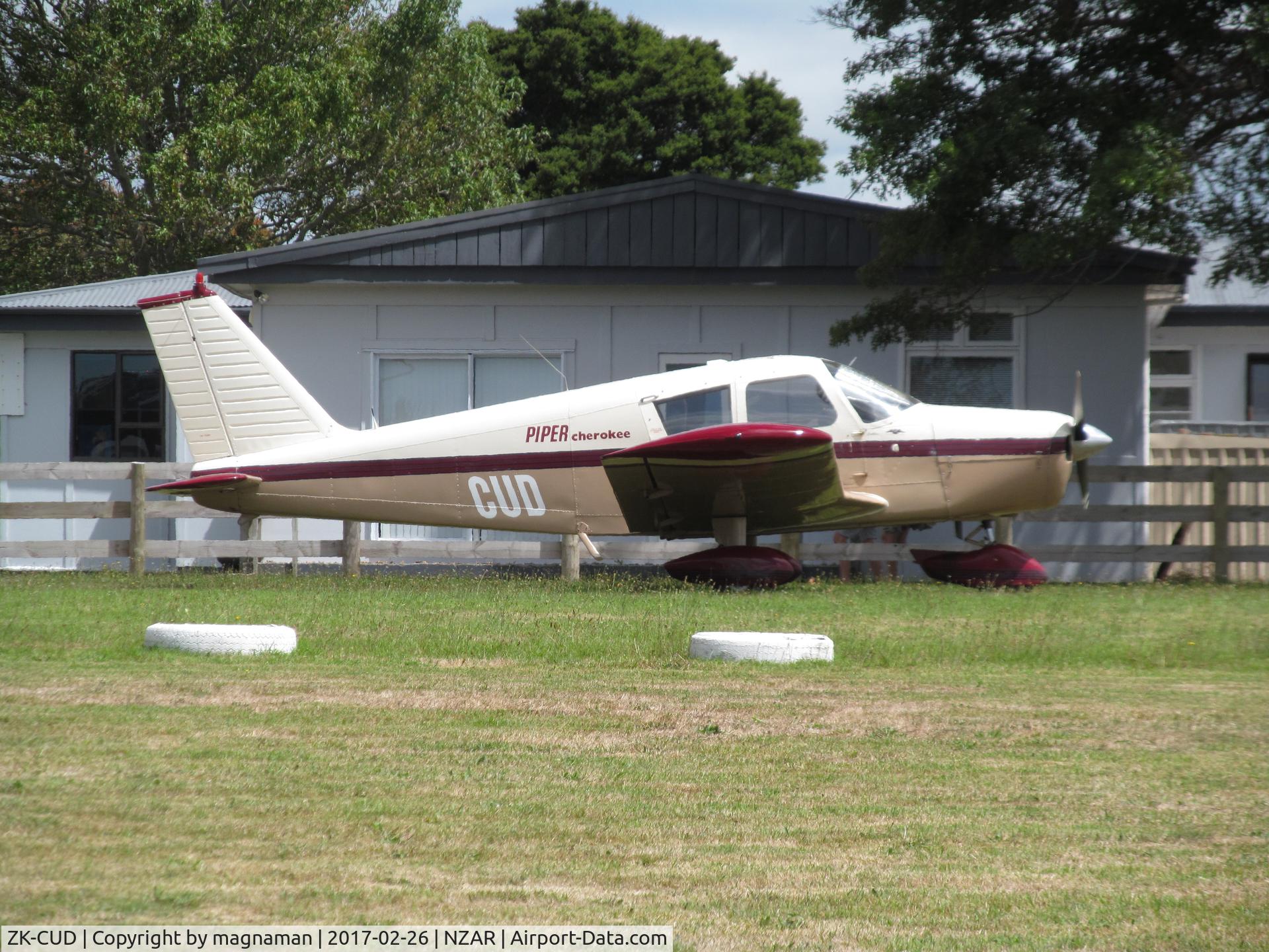 ZK-CUD, Piper PA-28-140 Cherokee C/N 28-23557, on grass at ardmore