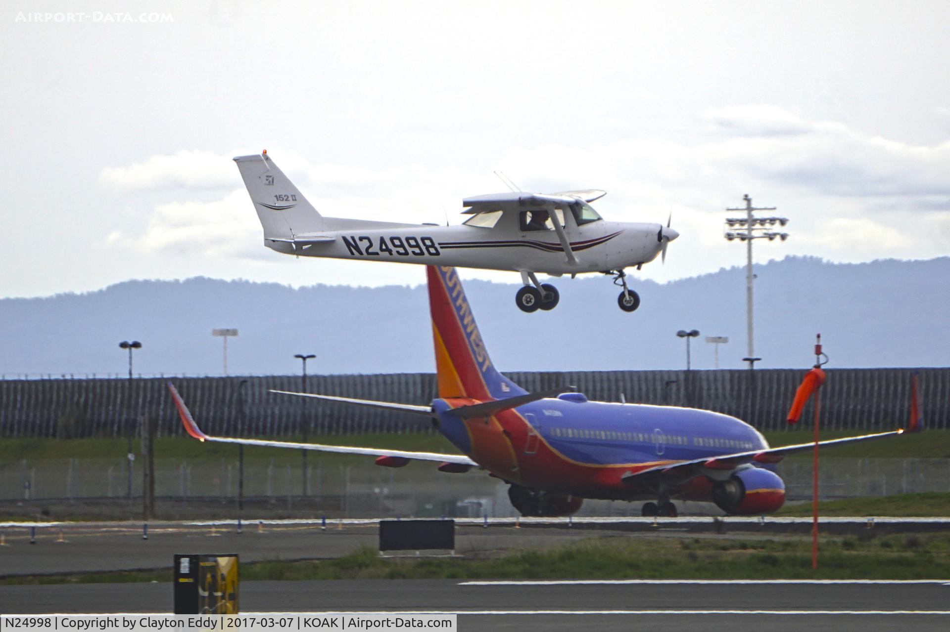 N24998, 1977 Cessna 152 C/N 15280503, Landing 28R North Field Oakland Airport.