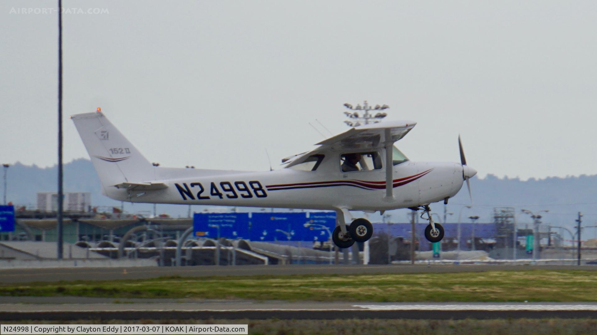 N24998, 1977 Cessna 152 C/N 15280503, Landing 28R North Field Oakland Airport.