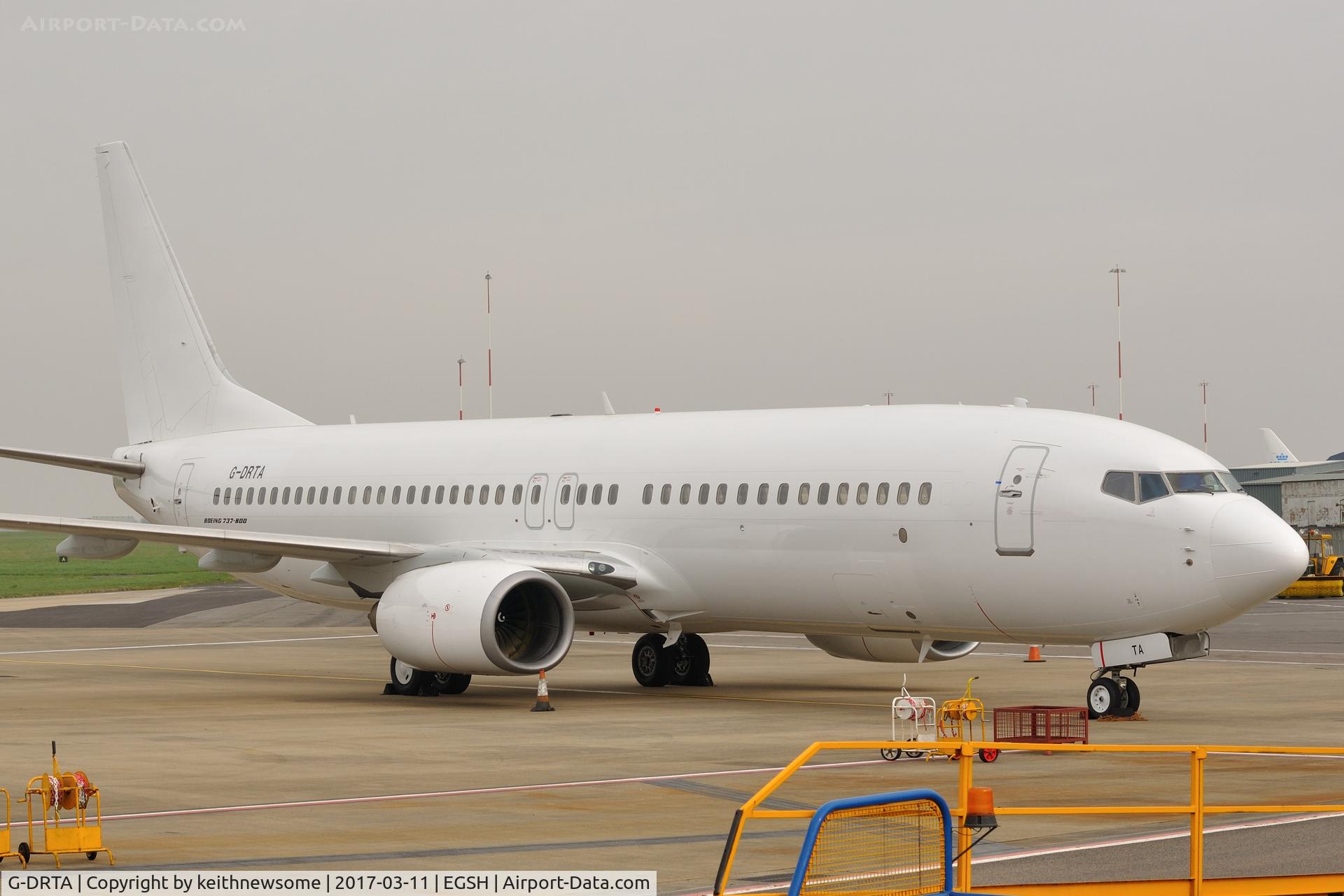 G-DRTA, 2004 Boeing 737-85P C/N 33972, Parked amongst ground equipment.