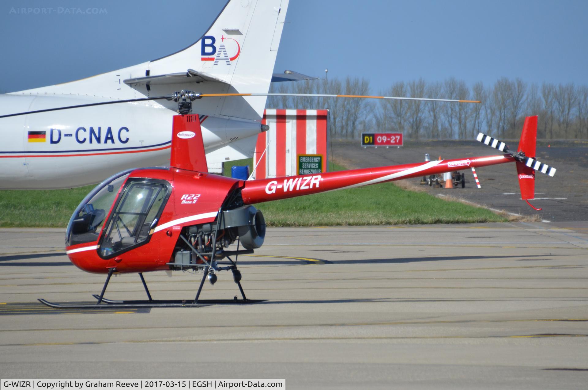 G-WIZR, 1998 Robinson R22 Beta II C/N 2799, Parked at Norwich.