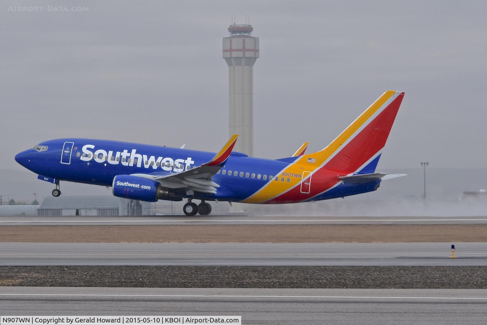 N907WN, 2008 Boeing 737-7H4 C/N 36619, Taking off on a wet afternoon on RWY 10L.