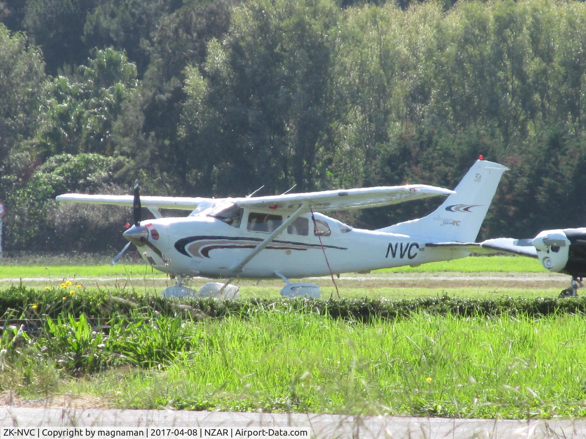 ZK-NVC, 2000 Cessna T206H Turbo Stationair C/N T20608185, long shot across grass to ?new resident?