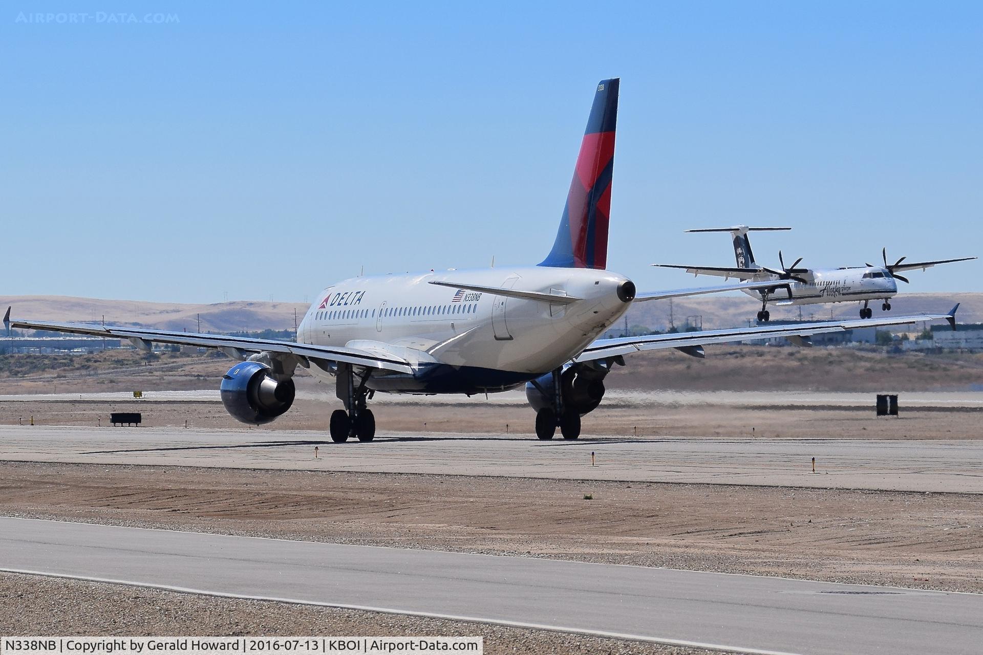 N338NB, 2002 Airbus A319-114 C/N 1693, Taxiing on Alpha to RWY 28R whileN421QX is landing.