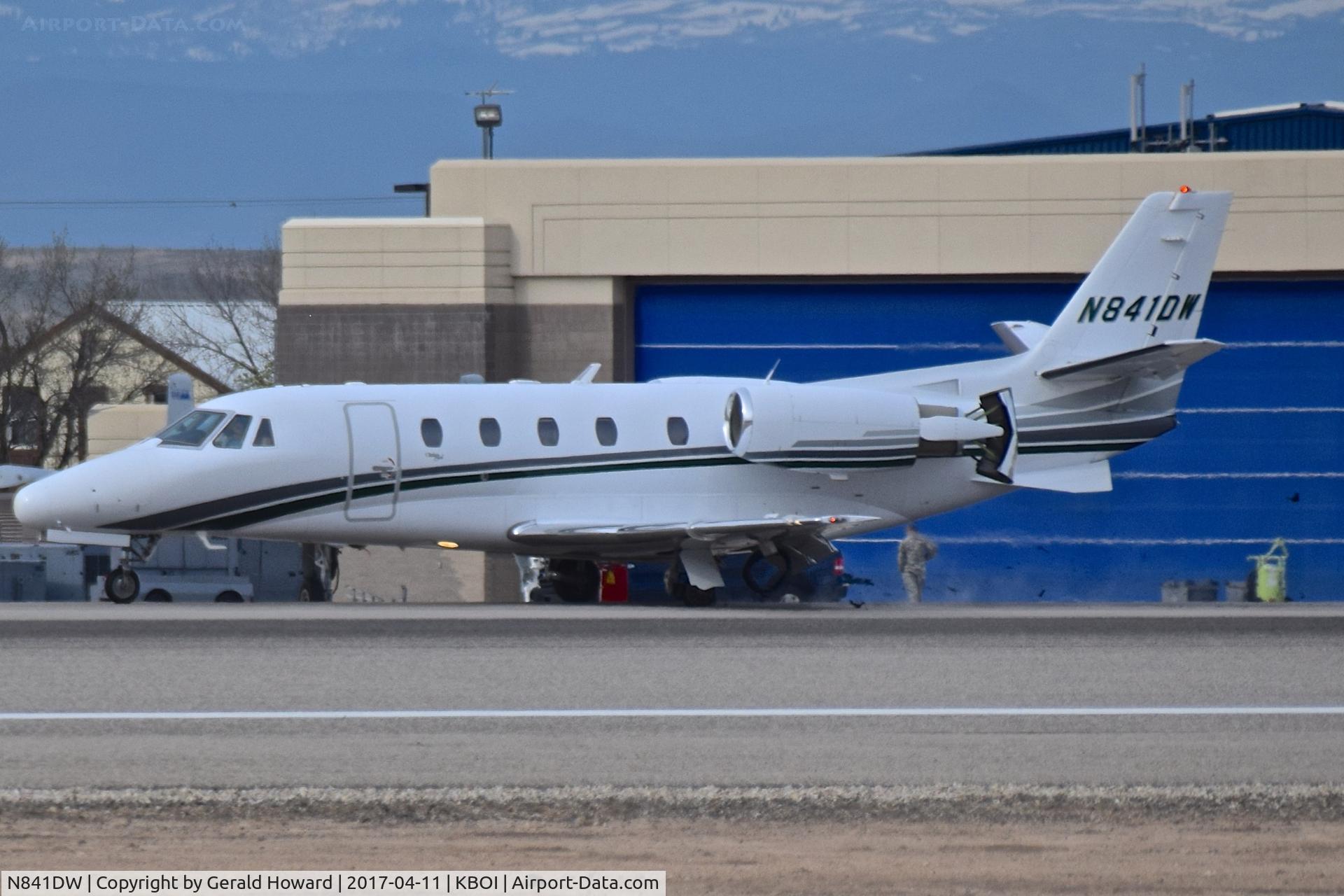 N841DW, 2001 Cessna 560XL C/N 560-5177, Landing roll out on RWY 10R. Debris under engine is blown left main tire.