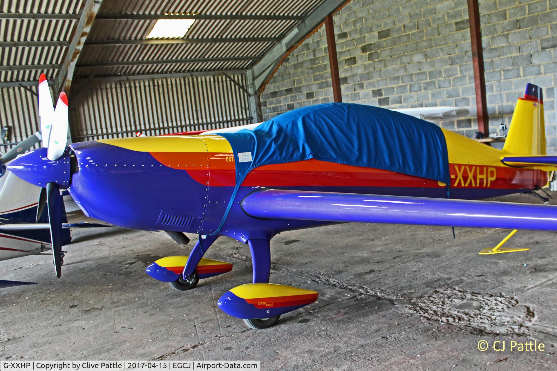 G-XXHP, 2000 Extra EA-300L C/N 203, Hangared at EGCJ