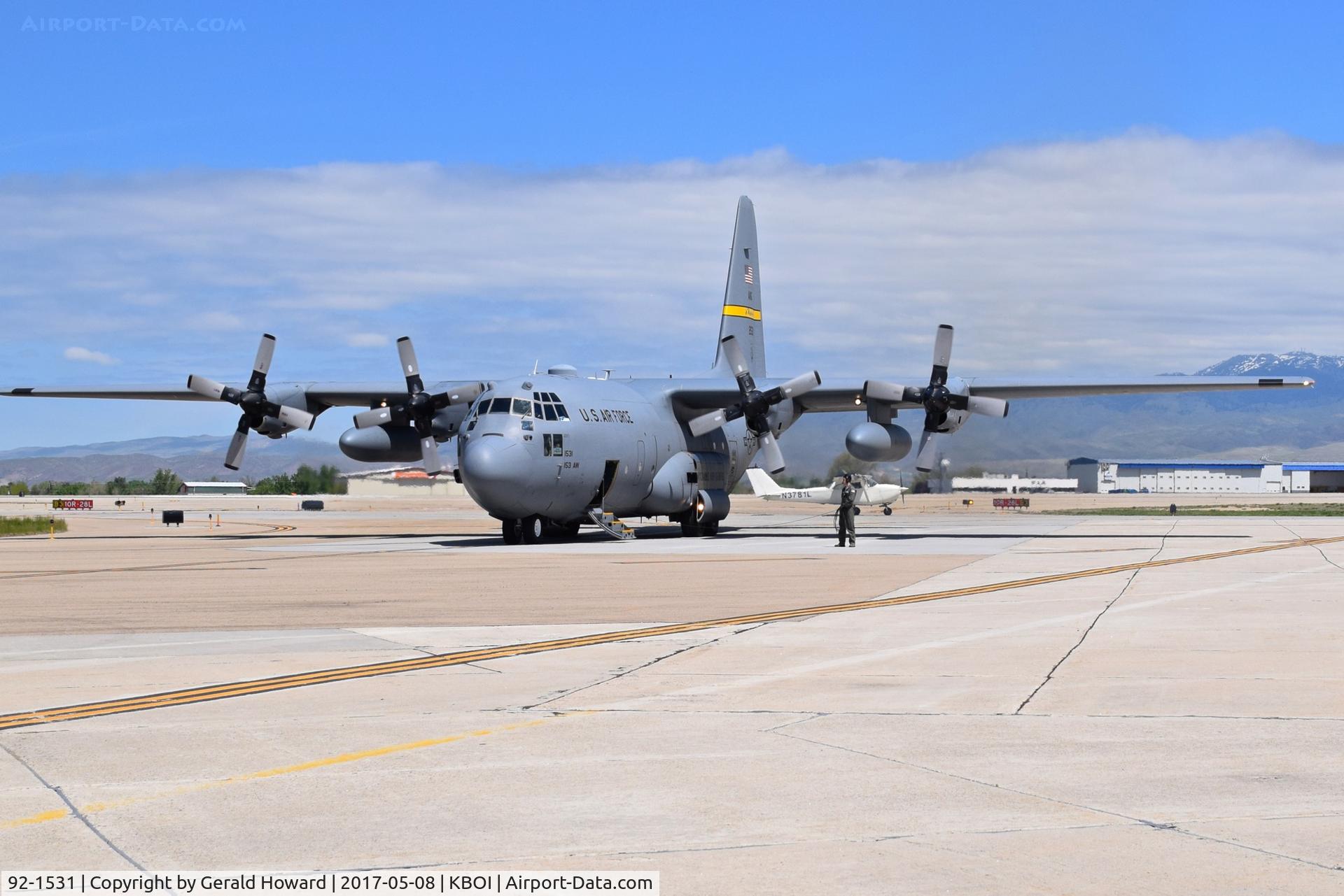 92-1531, 1992 Lockheed C-130H Hercules C/N 382-5310, Stopped with engines running while trying to find parking spot. Cessna snuck in behind.  153rd AW, Wyoming ANG.