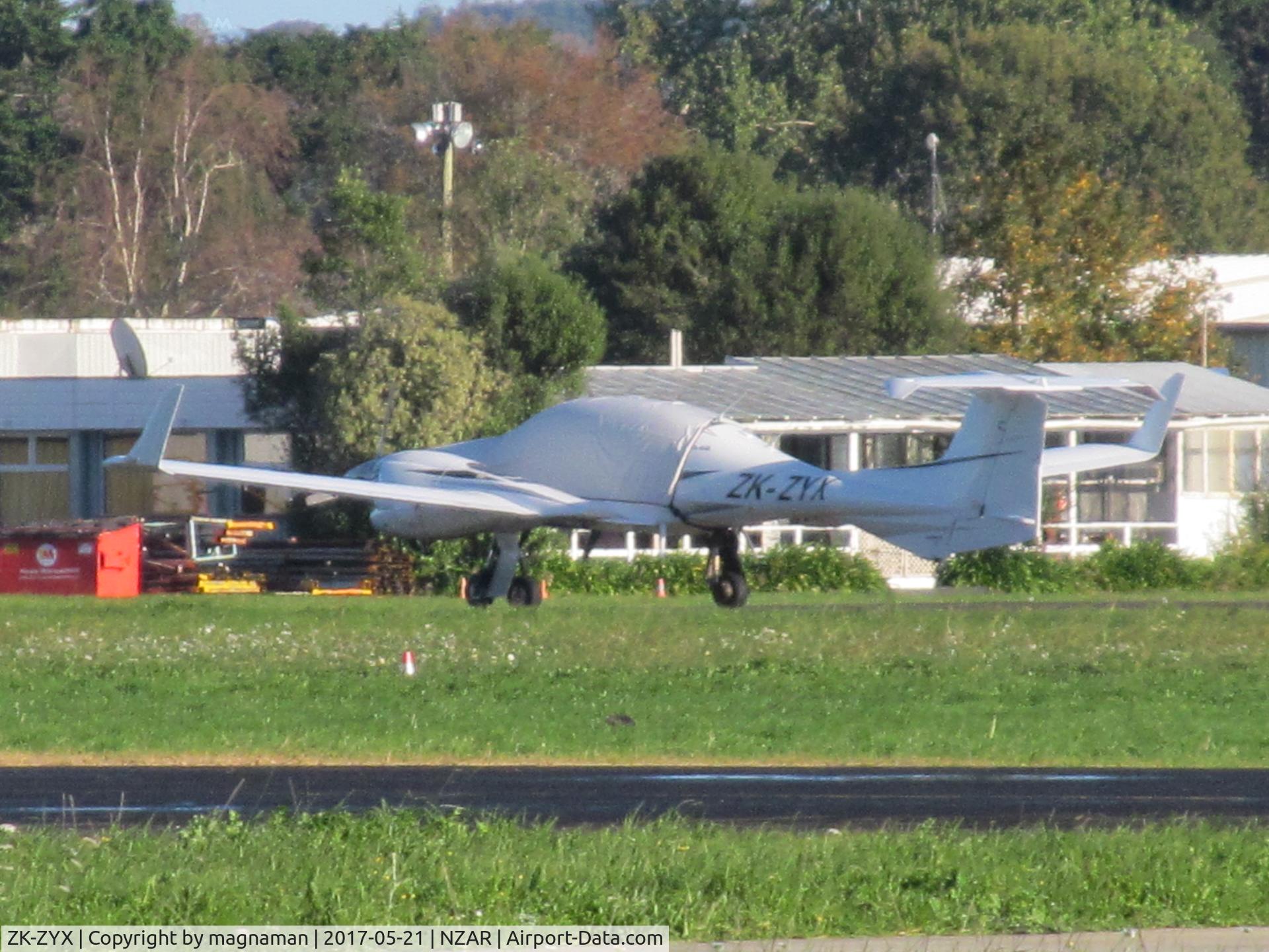 ZK-ZYX, Diamond DA-42 Twin Star C/N 42.AC126, long range across field shot of resident