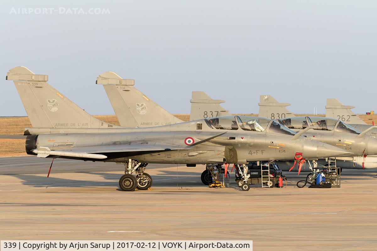 339, 2013 Dassault Rafale B C/N 339, The evening sun bathes the flight line at Aero India 2017. Three Swedish Air Force Gripens are parked in the background.