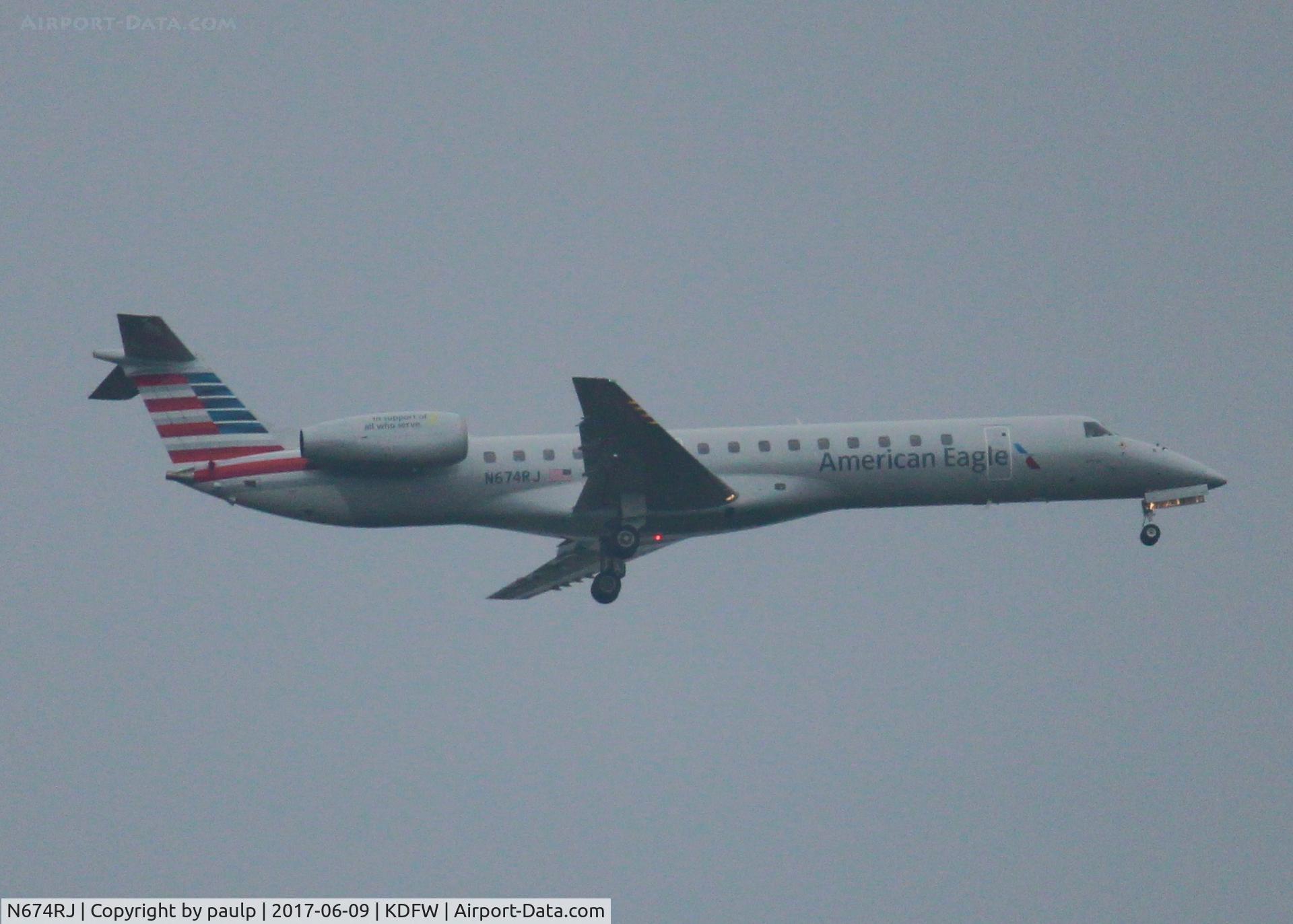 N674RJ, 2004 Embraer ERJ-145LR (EMB-145LR) C/N 14500801, At DFW. After a 45 minute hold because of severe storms, starting to land in heavy rain.