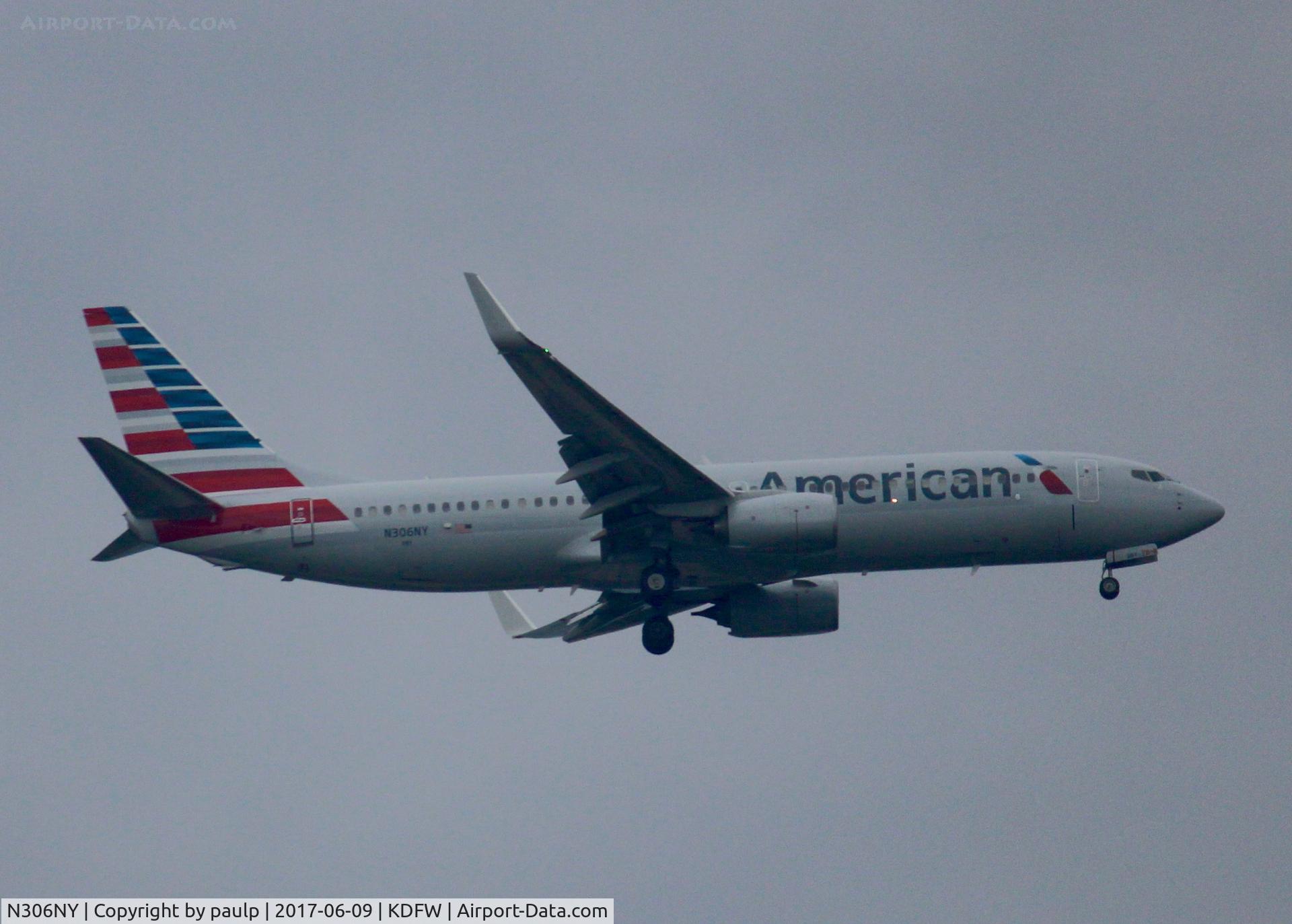 N306NY, 2016 Boeing 737-800 C/N 33343, At DFW. After a 45 minute hold because of severe storms, starting to land in heavy rain.