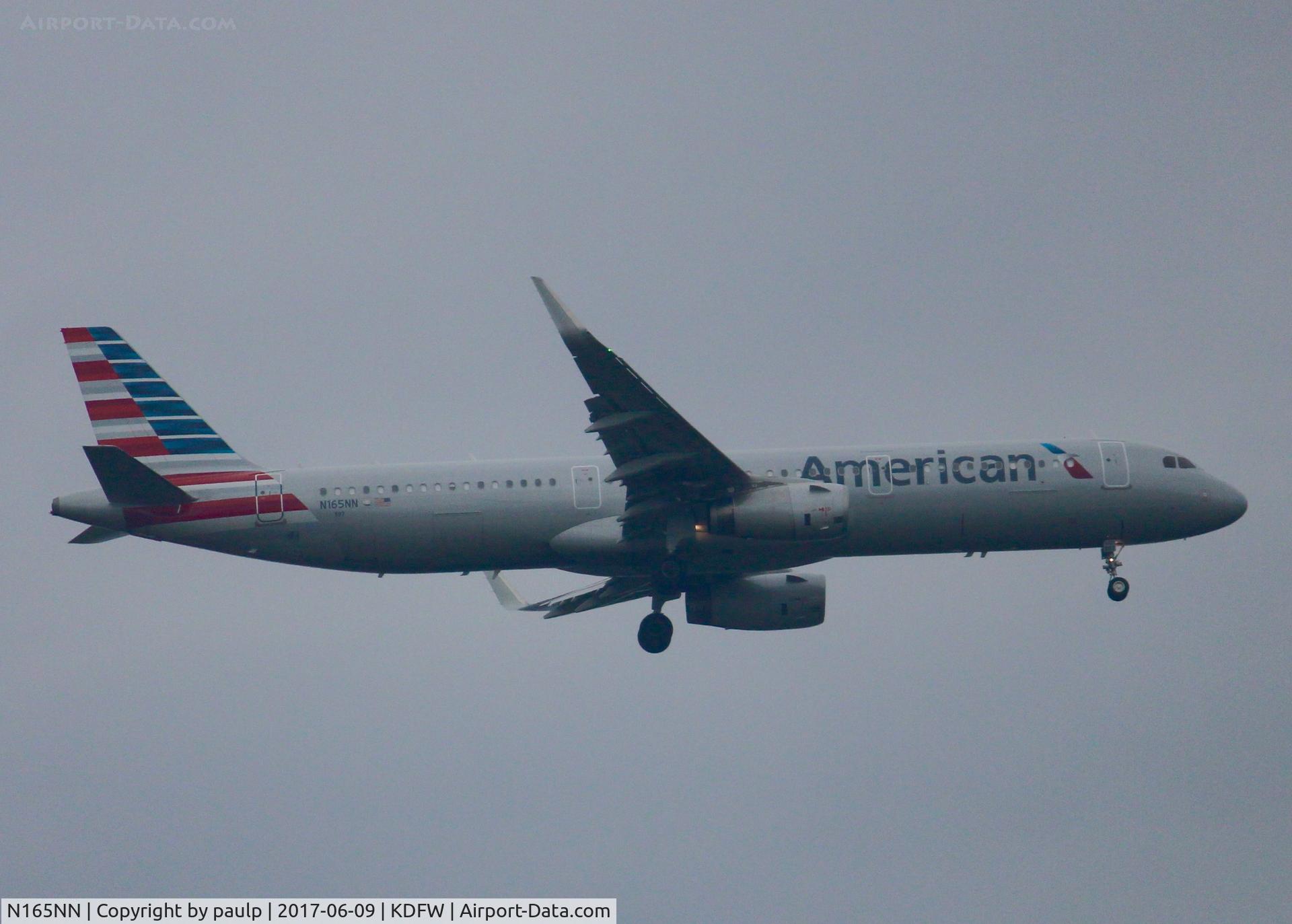 N165NN, 2016 Airbus A321-231 C/N 6956, At DFW. After a 45 minute hold because of severe storms, starting to land in heavy rain.