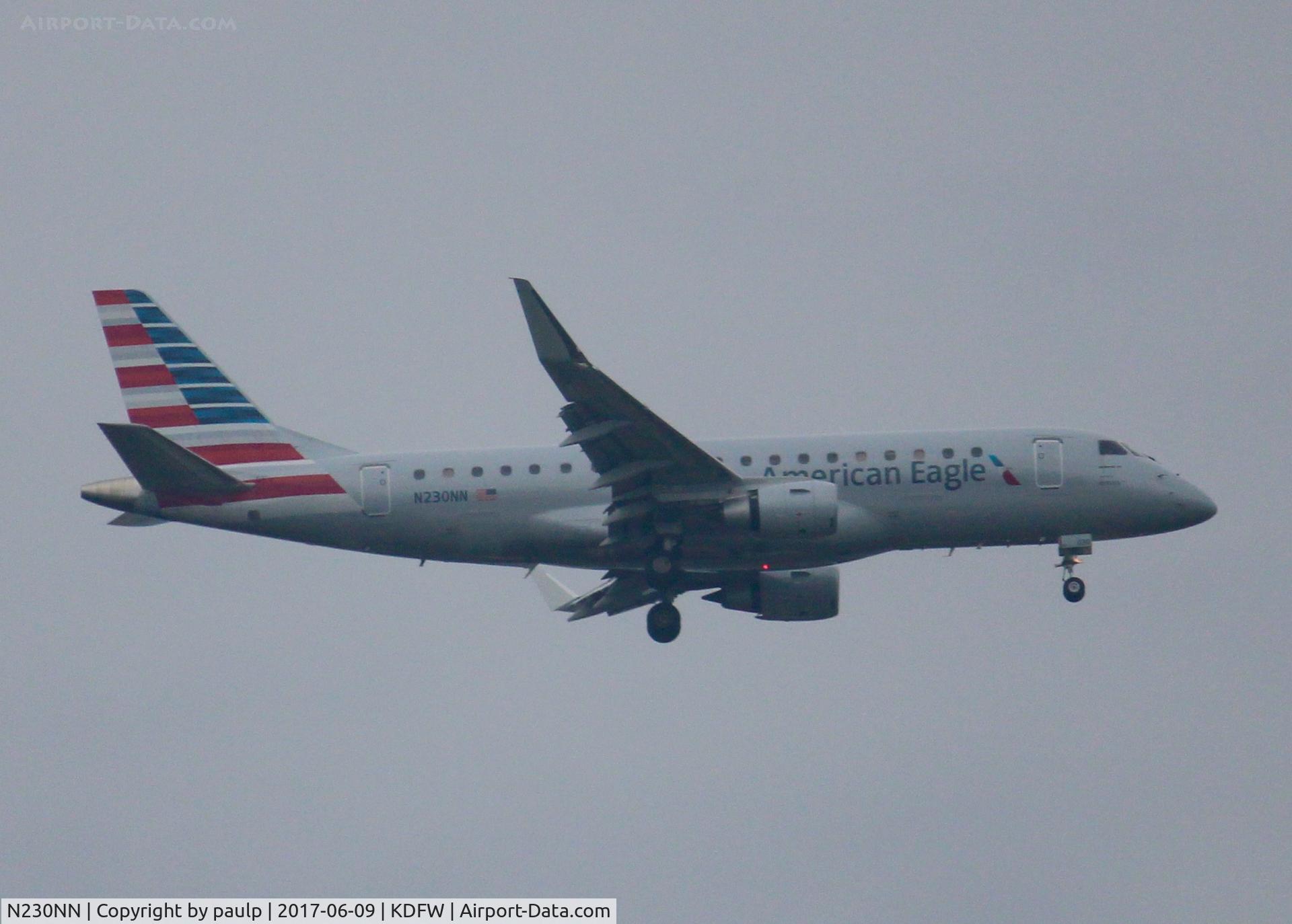 N230NN, 2016 Embraer 175LR (ERJ-170-200LR) C/N 17000550, At DFW. After a 45 minute hold because of severe storms, starting to land in heavy rain.