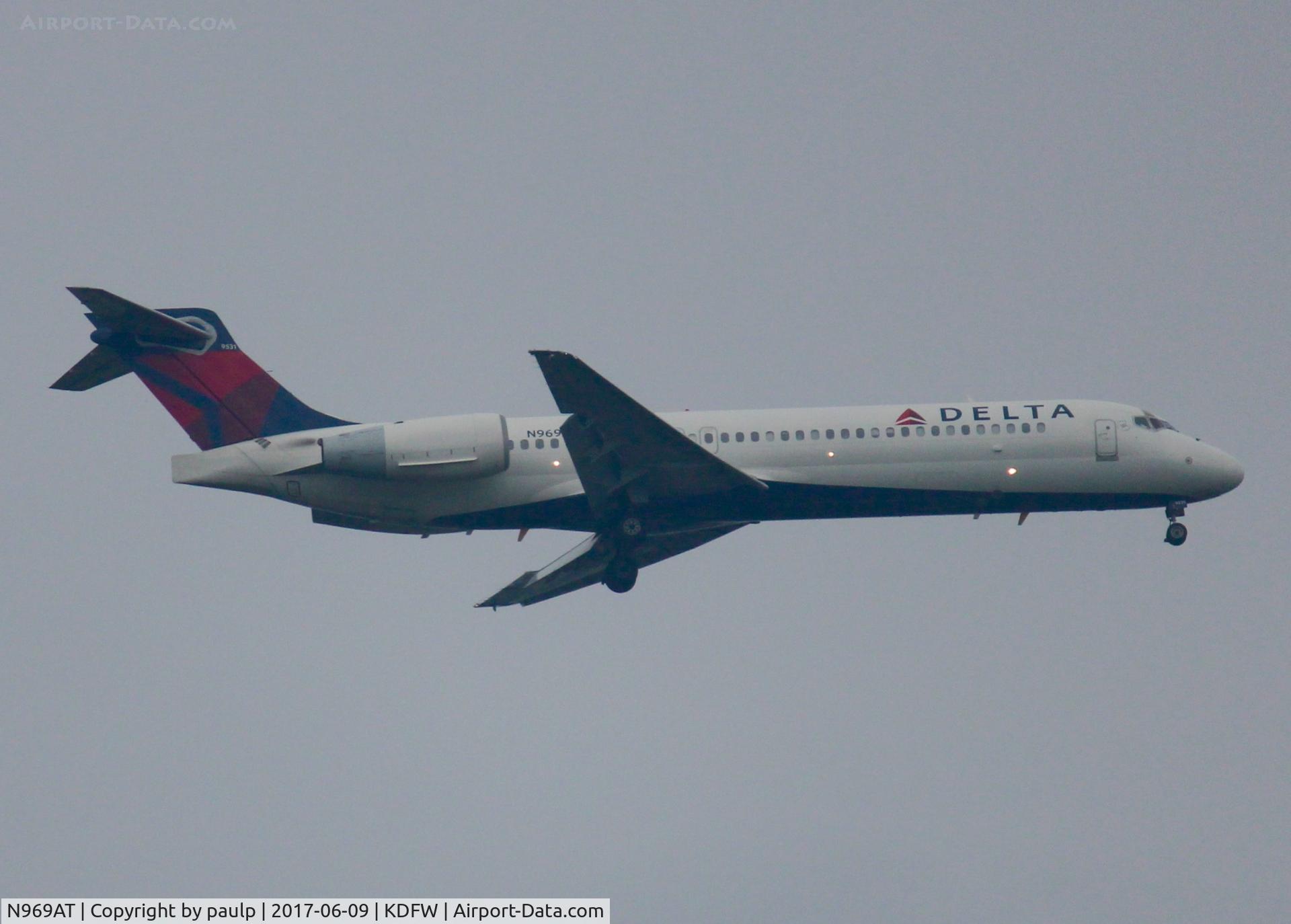 N969AT, 2001 Boeing 717-200 C/N 55030, At DFW. After a 45 minute hold because of severe storms, starting to land in heavy rain.