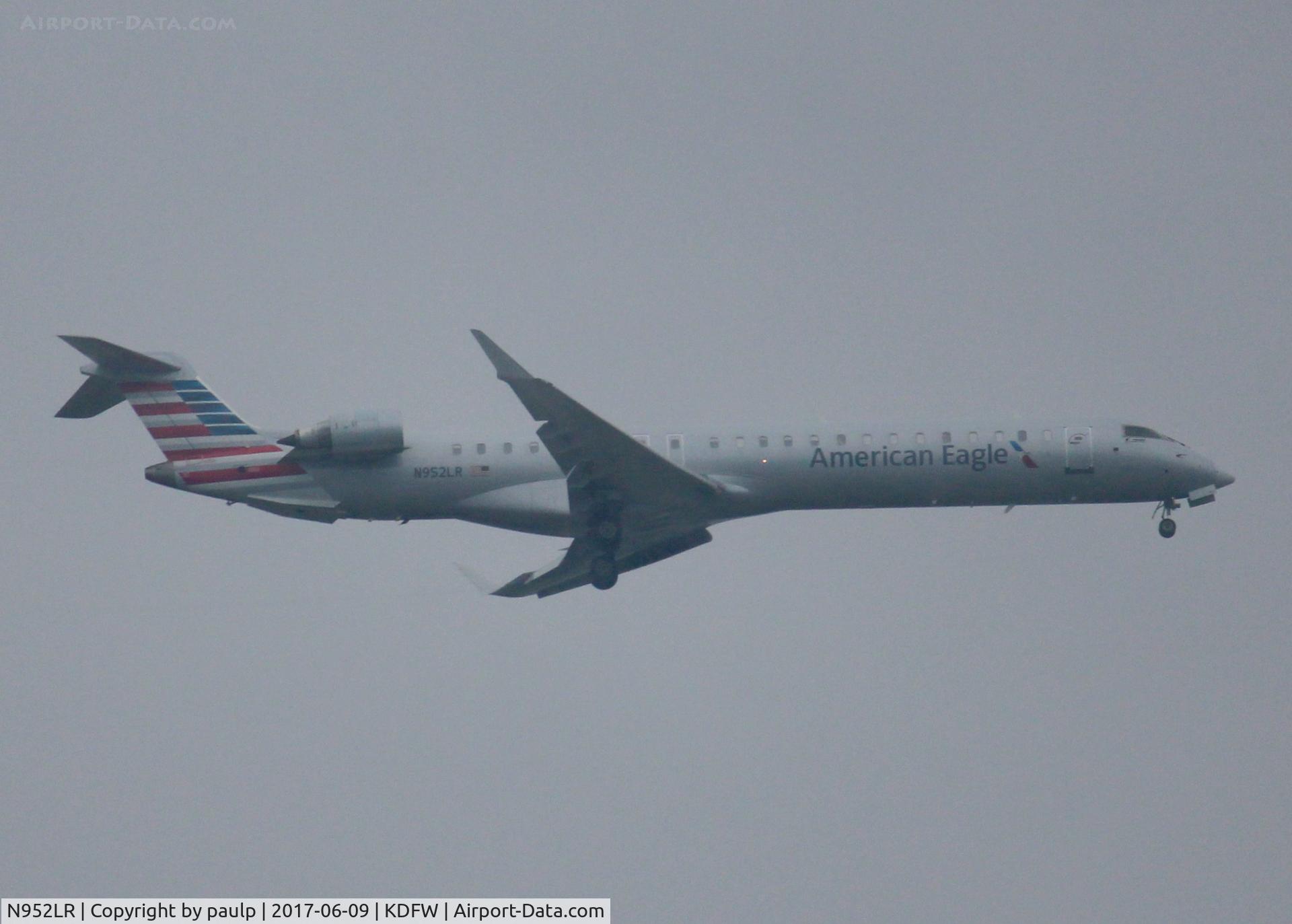 N952LR, 2015 Bombardier CRJ-900LR (CL-600-2D24) C/N 15373, At DFW. After a 45 minute hold because of severe storms, starting to land in heavy rain.
