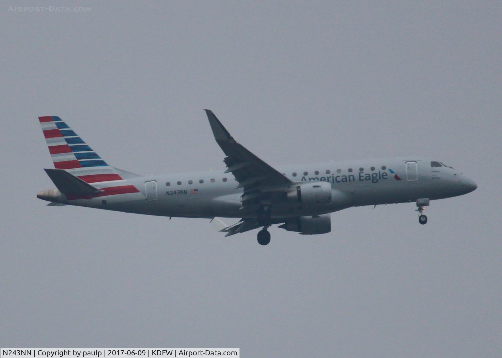 N243NN, 2016 Embraer 175LR (ERJ-170-200LR) C/N 17000604, At DFW. After a 45 minute hold because of severe storms, starting to land in heavy rain.