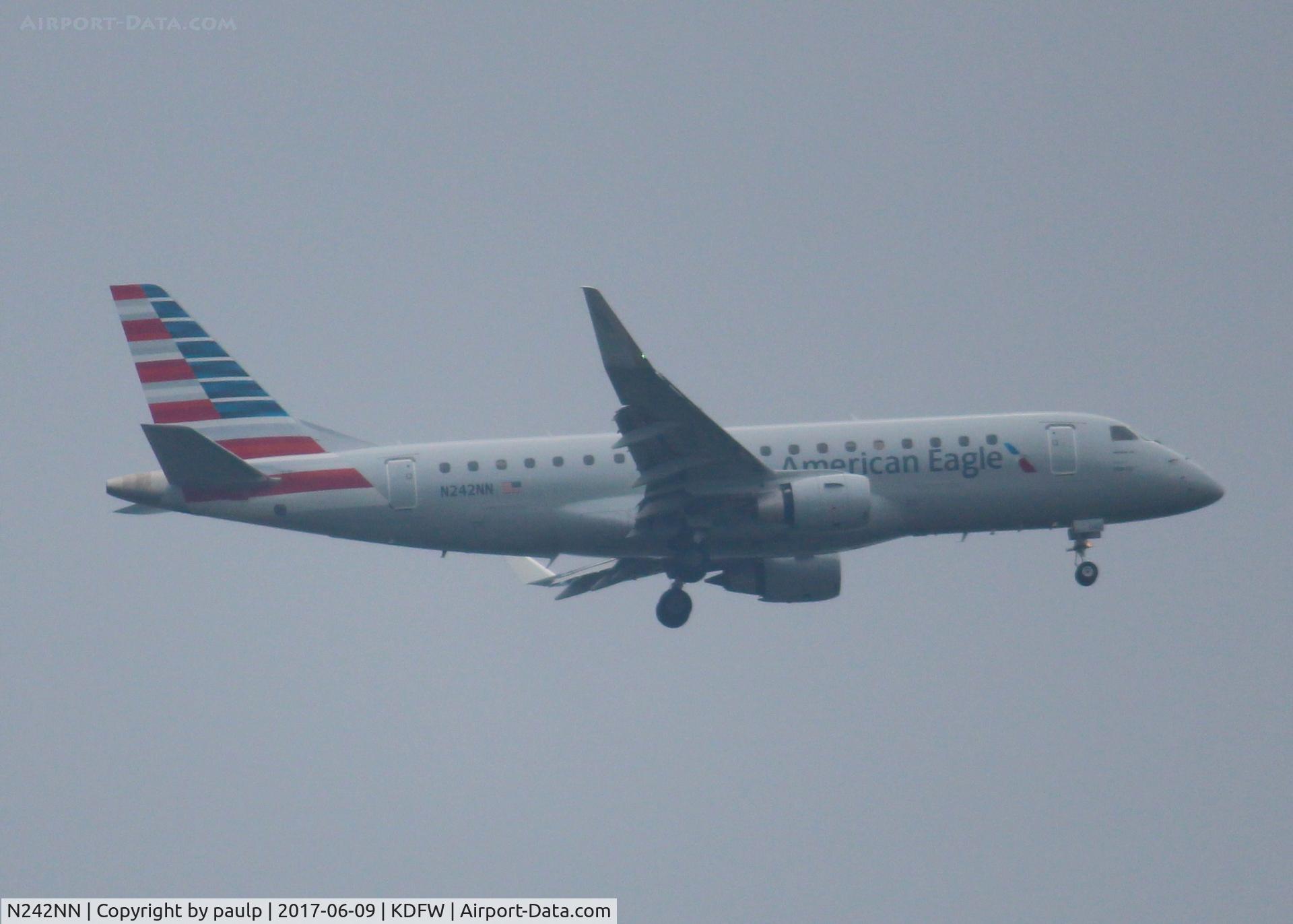N242NN, 2016 Embraer 175LR (ERJ-170-200LR) C/N 17000601, At DFW. After a 45 minute hold because of severe storms, starting to land in heavy rain.