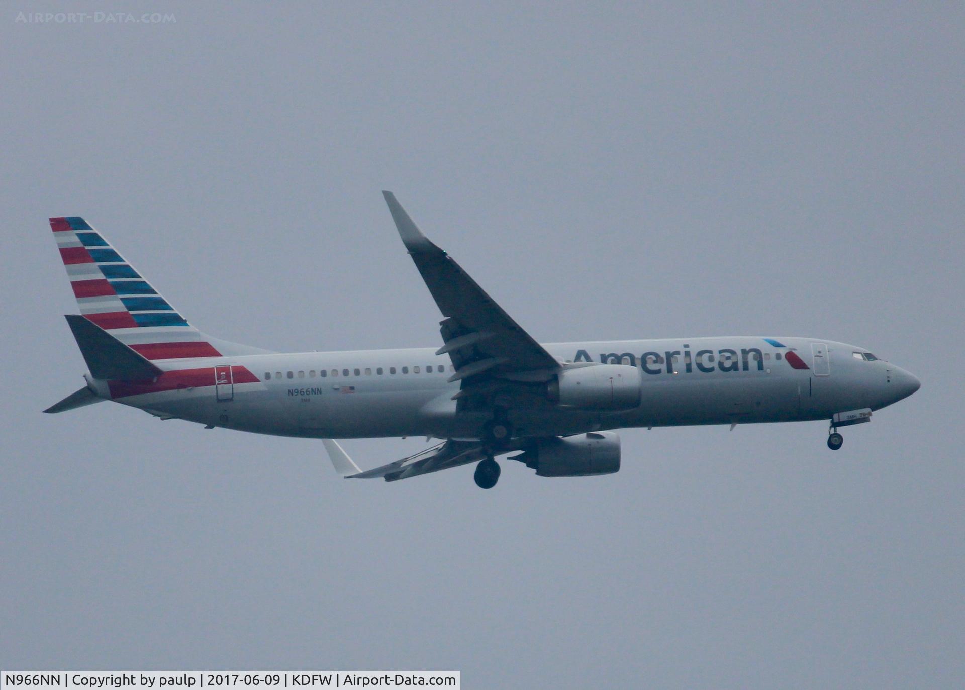 N966NN, 2015 Boeing 737-823 C/N 33240, At DFW. After a 45 minute hold because of severe storms, starting to land in heavy rain.