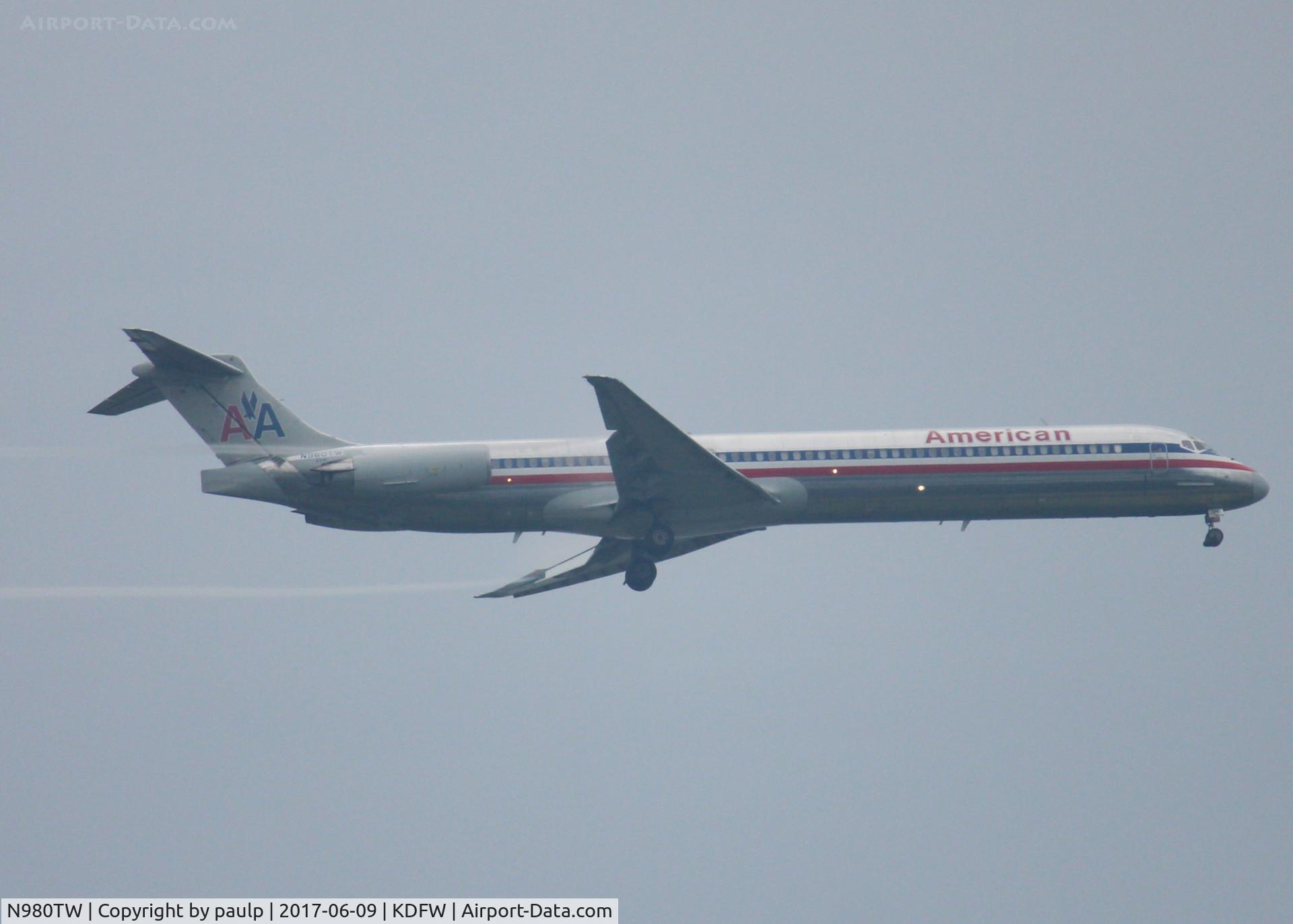 N980TW, 1999 McDonnell Douglas MD-83 (DC-9-83) C/N 53630, At DFW. After a 45 minute hold because of severe storms, starting to land in heavy rain.